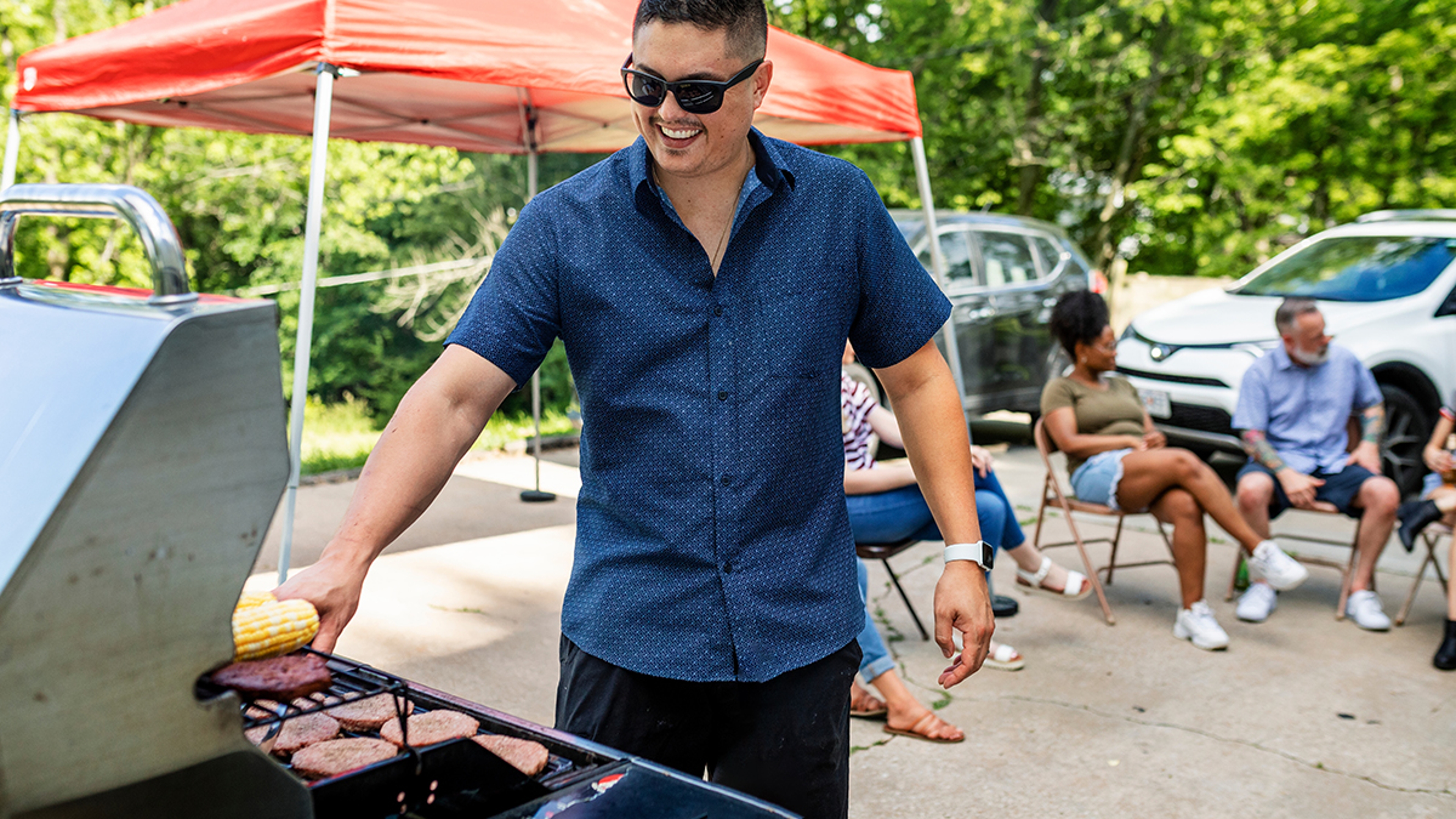 Manning the grill at a tailgate party