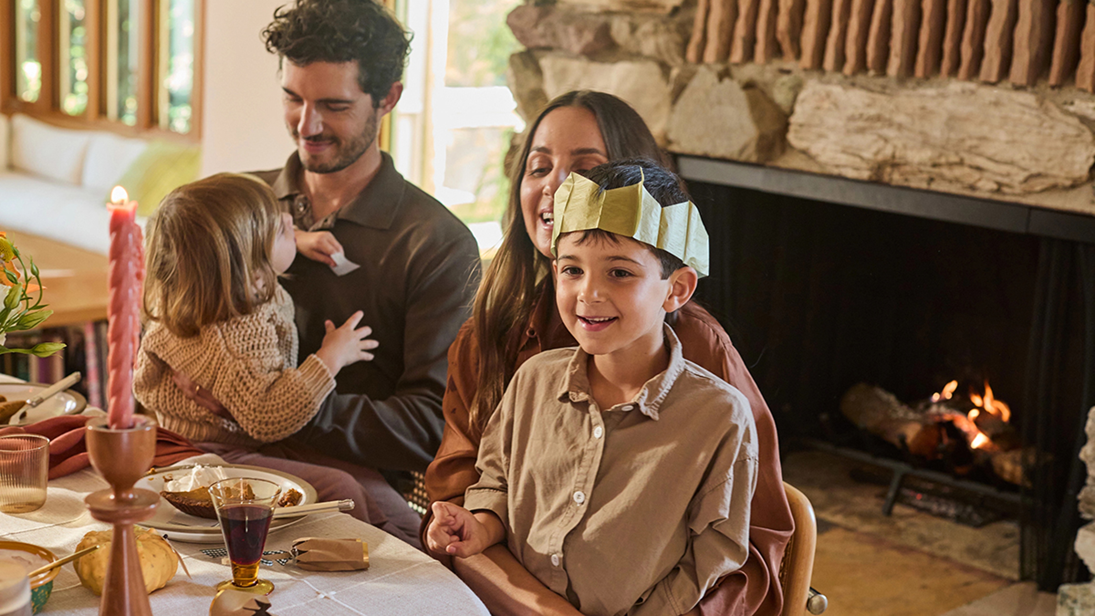 Family sitting at a table playing Thanksgiving games