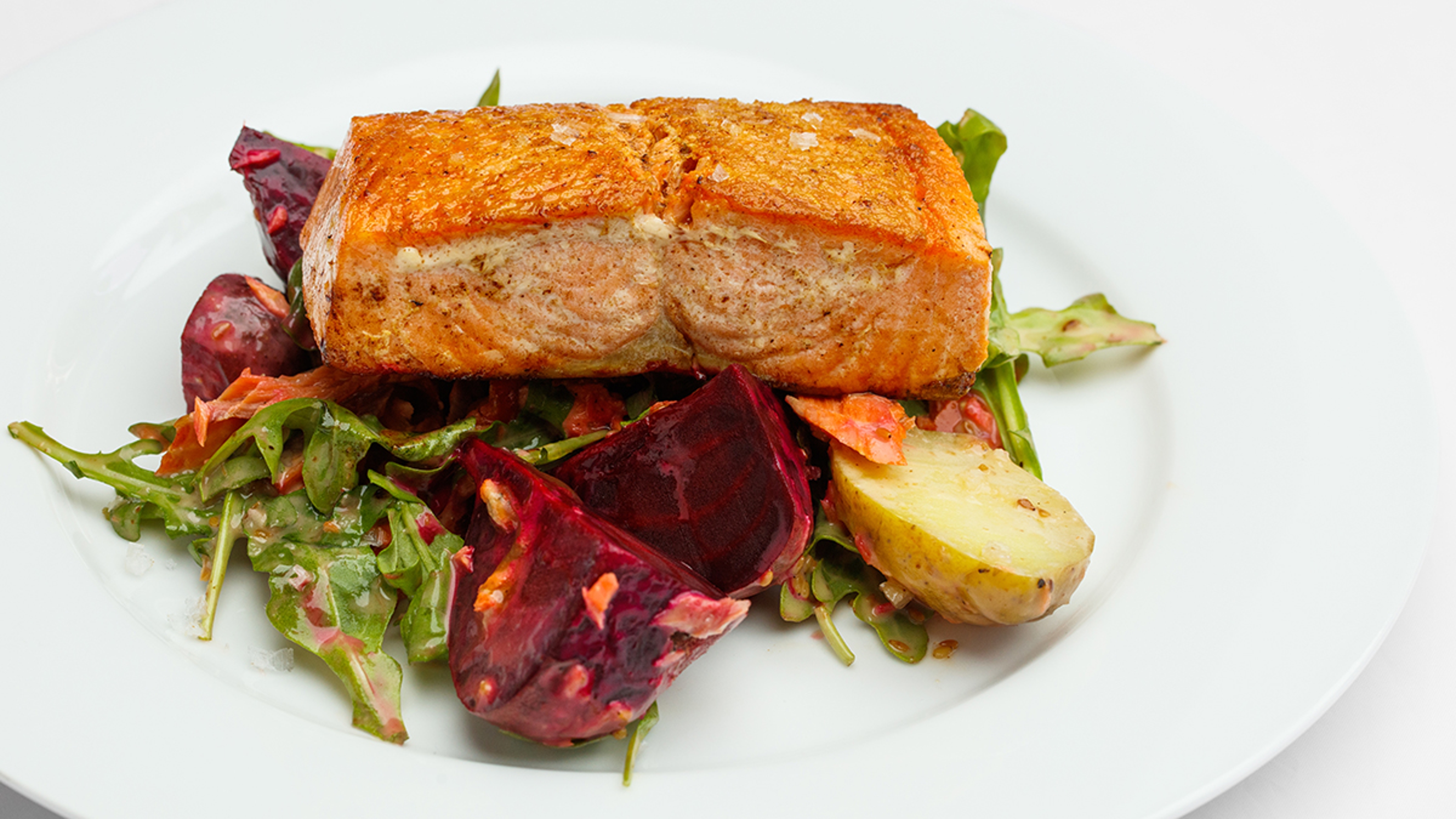 Filet of Copper River King salmon on a salad.