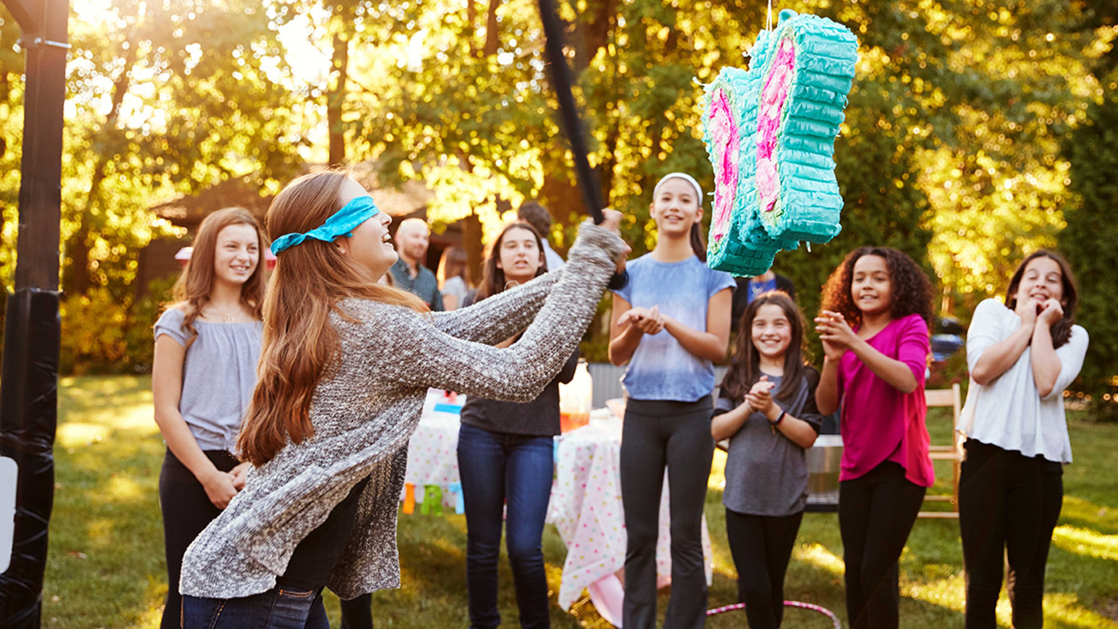 Article Cards Featured Image Friends watch teenage girl hitting a pi–ata on her birthday