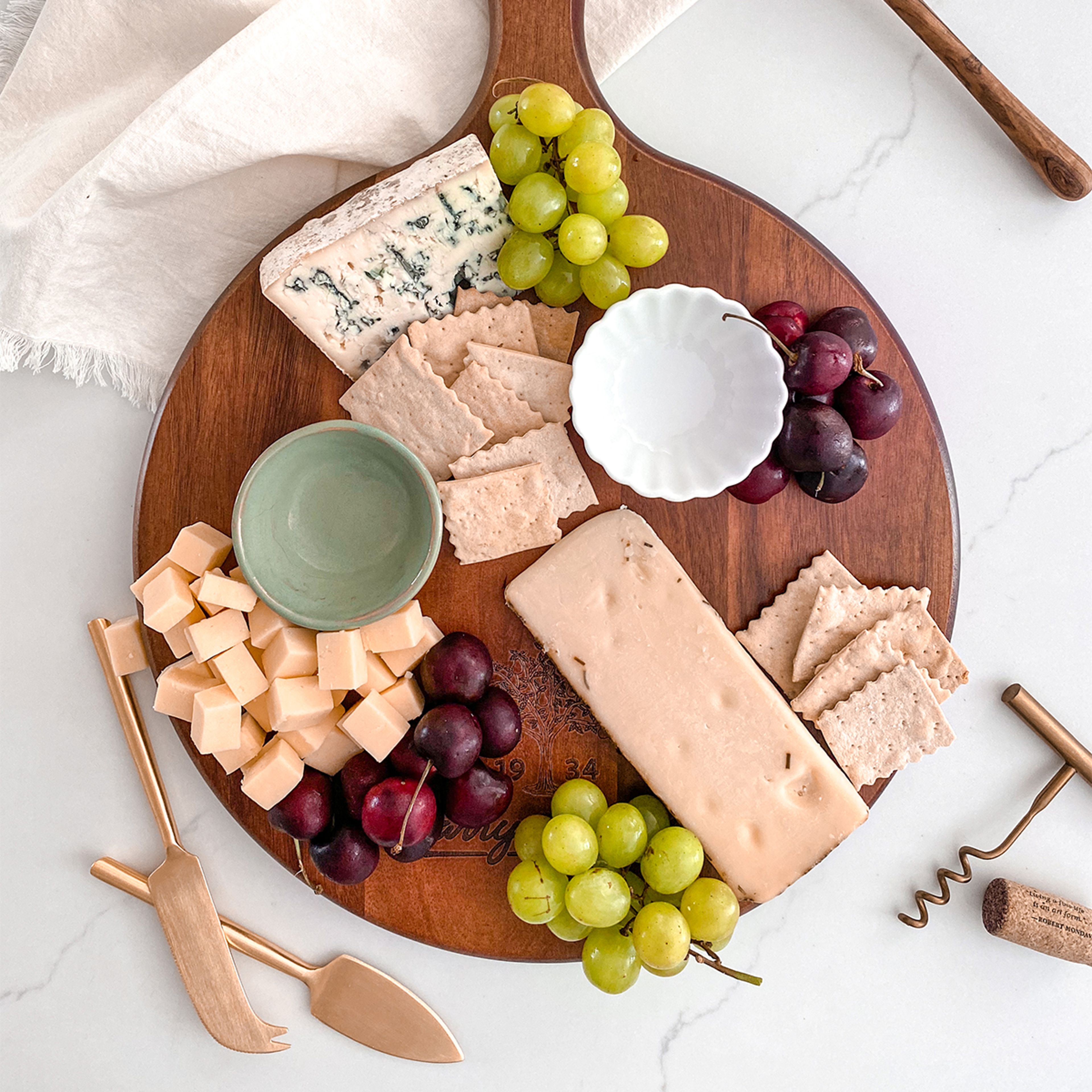 How to create a charcuterie board with cheese, fruit, and crackers.