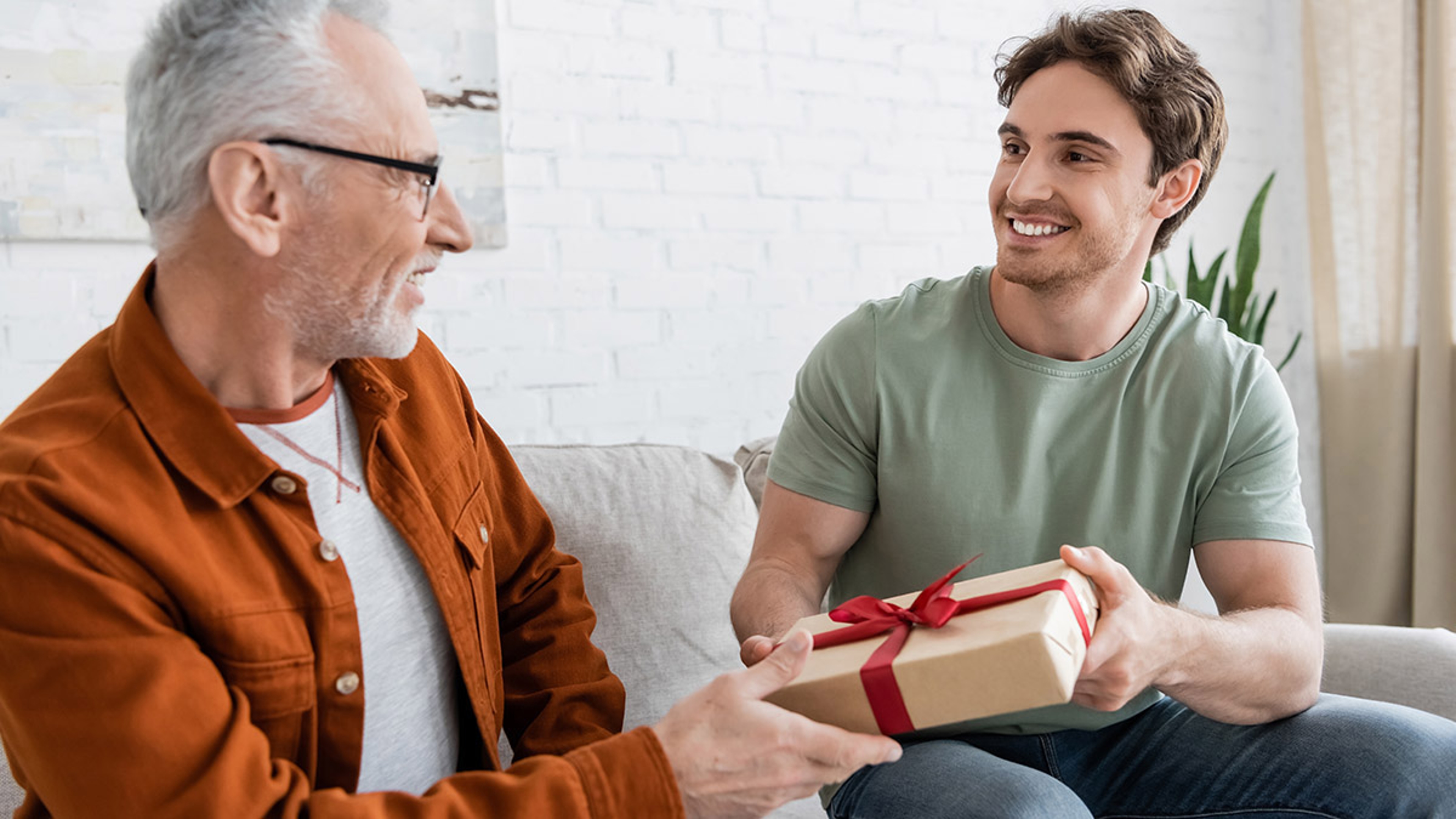 father in law gifts man handing a gift to a father figure