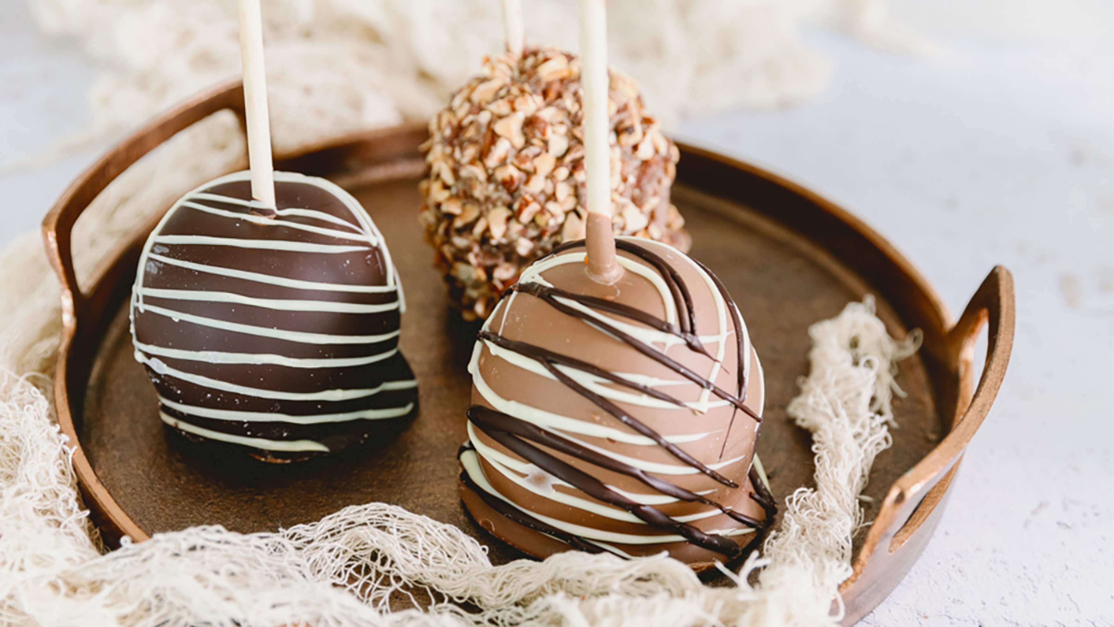 Caramel apples on a tray for a Halloween snack board.