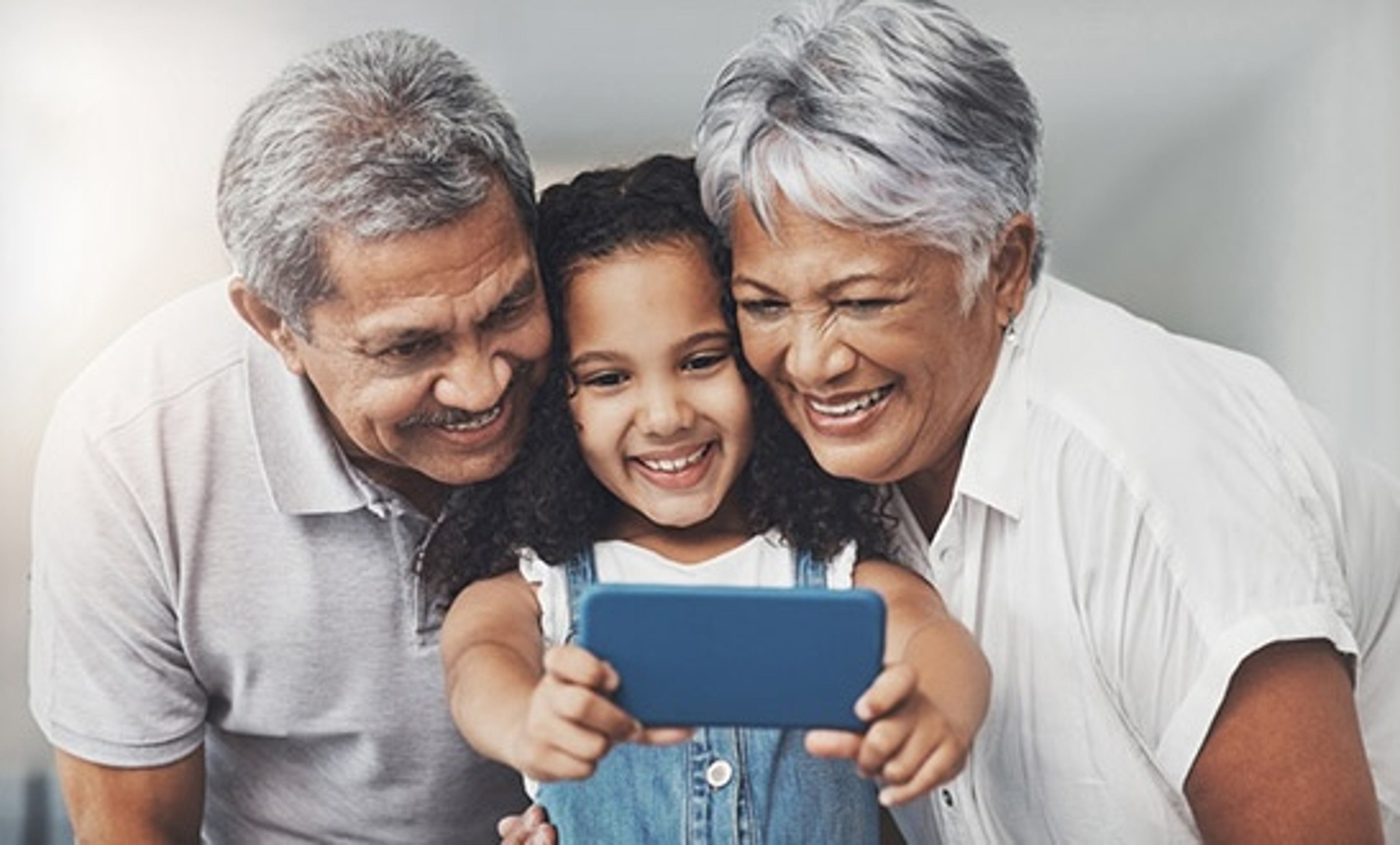 photo of grandparents looking at a phone