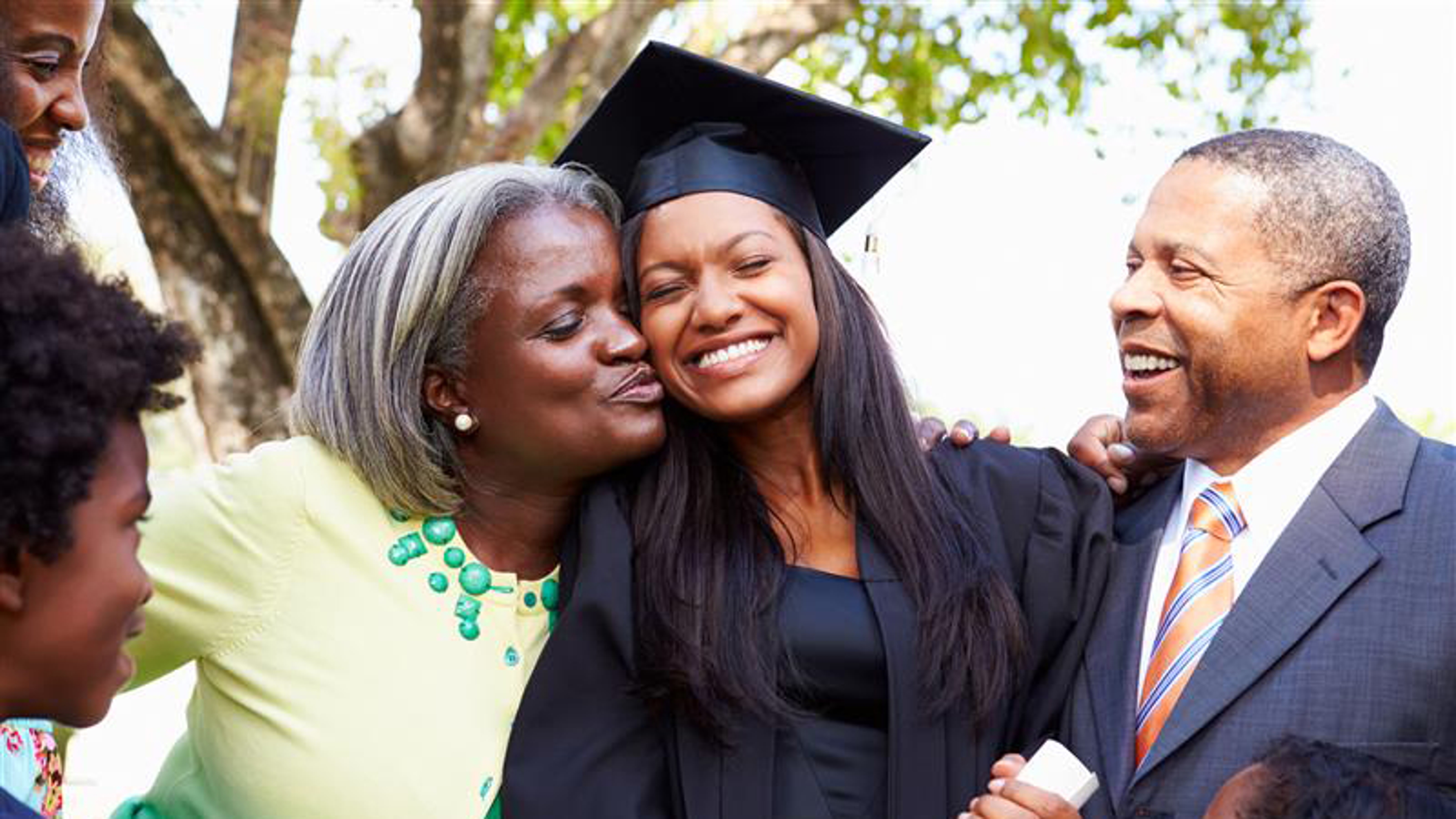 Family celebrating daughter graduating.