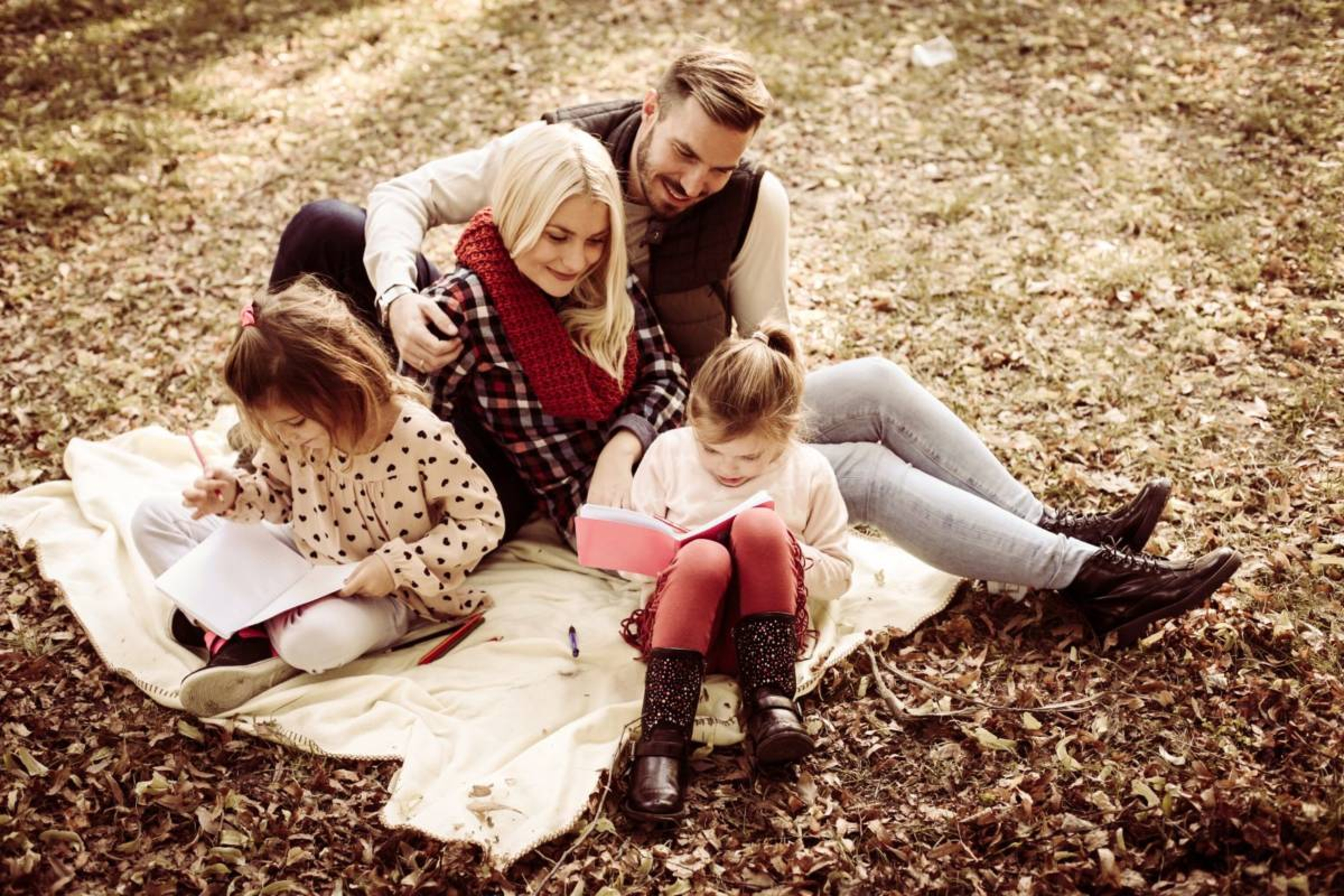 Article Cards Featured Image Photo of family sitting on a blanket in fall