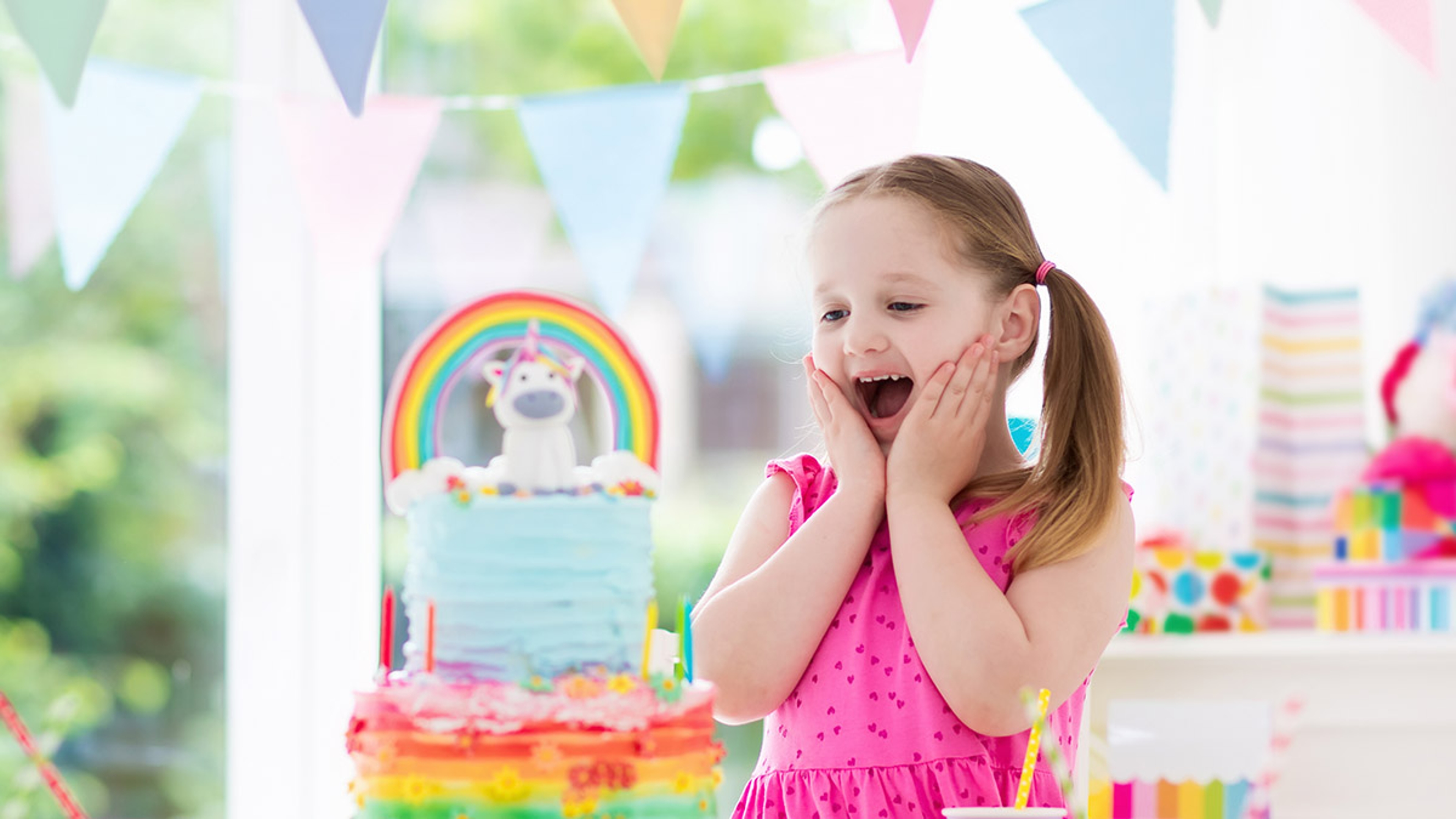 Kids birthday party. Little girl with cake.