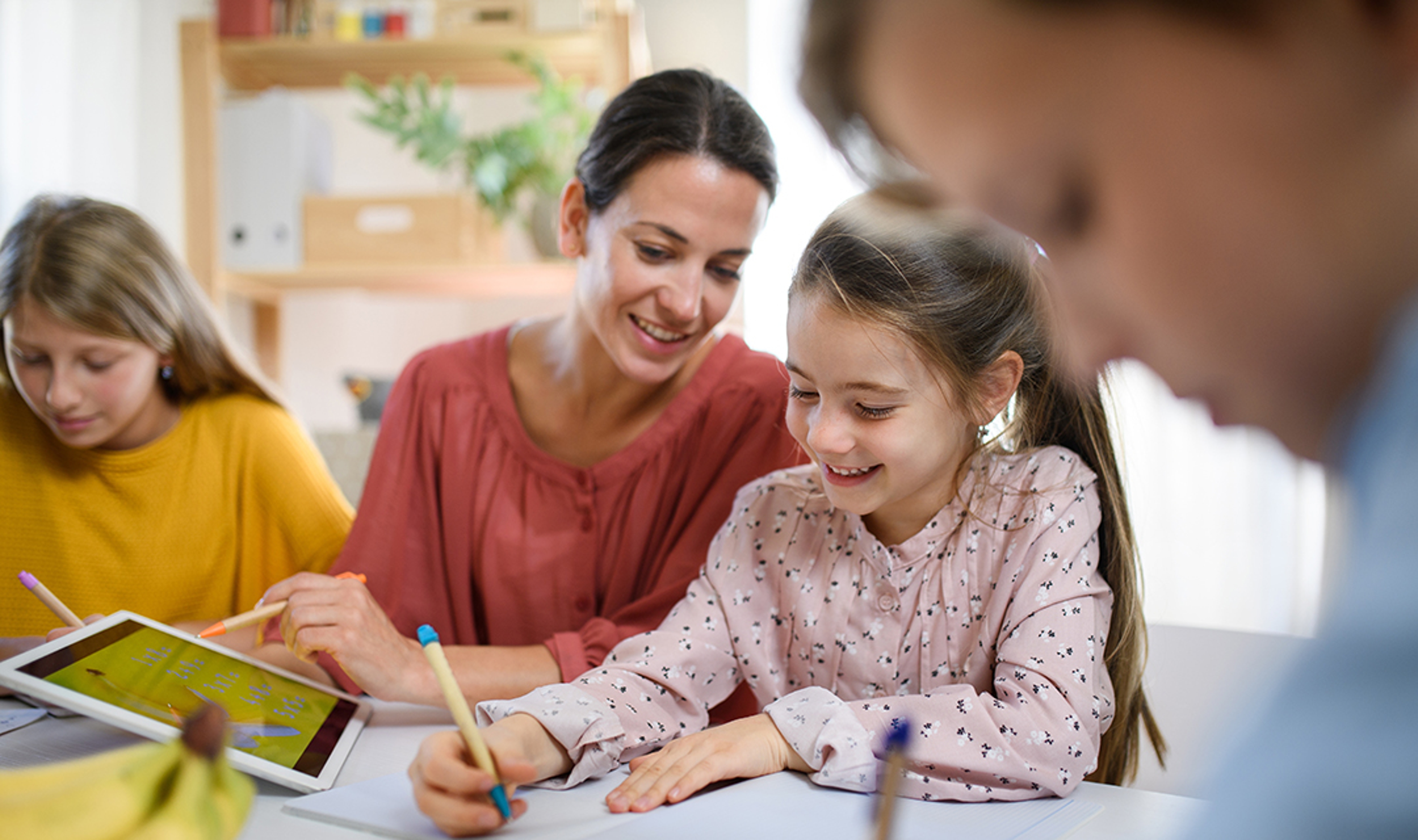 Group of homeschooling children with teacher studying indoors, coronavirus concept.