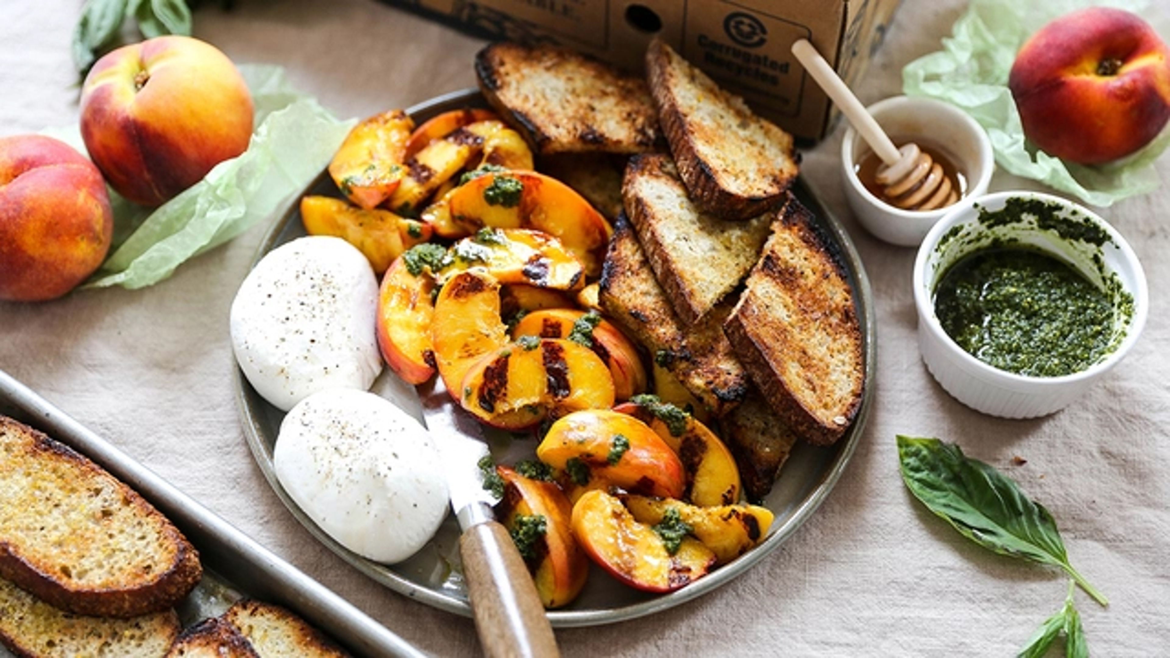 Platter with toast, grilled peaches, and burrata