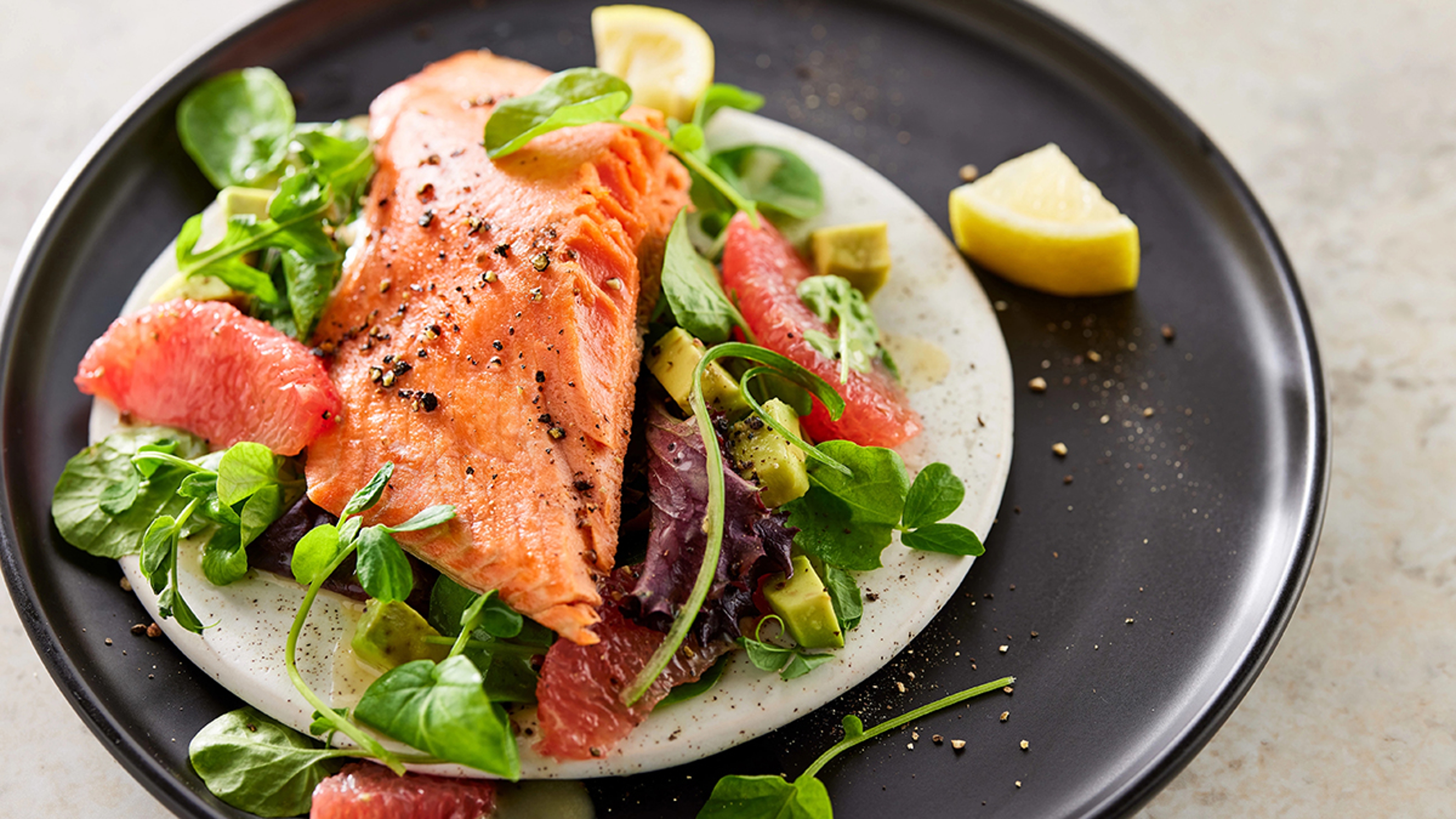 Salmon on a plate of greens.