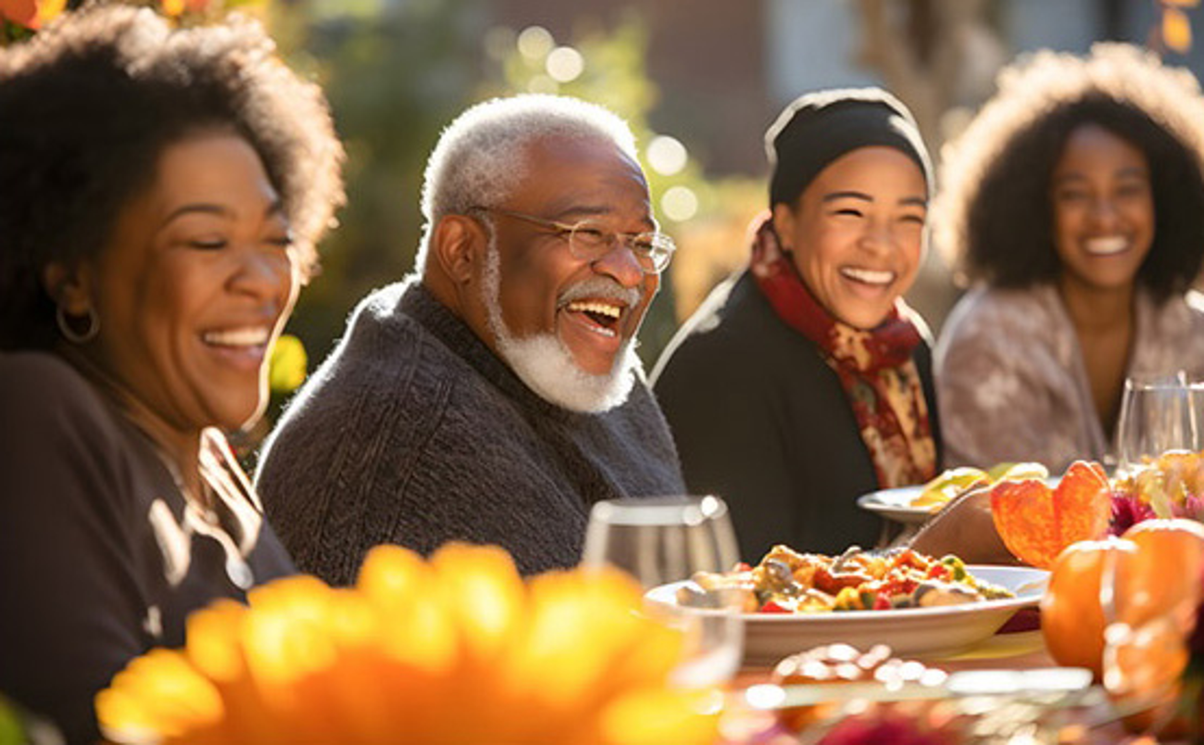 holiday rituals traditions photo people gathered around a festively decorated table laughing