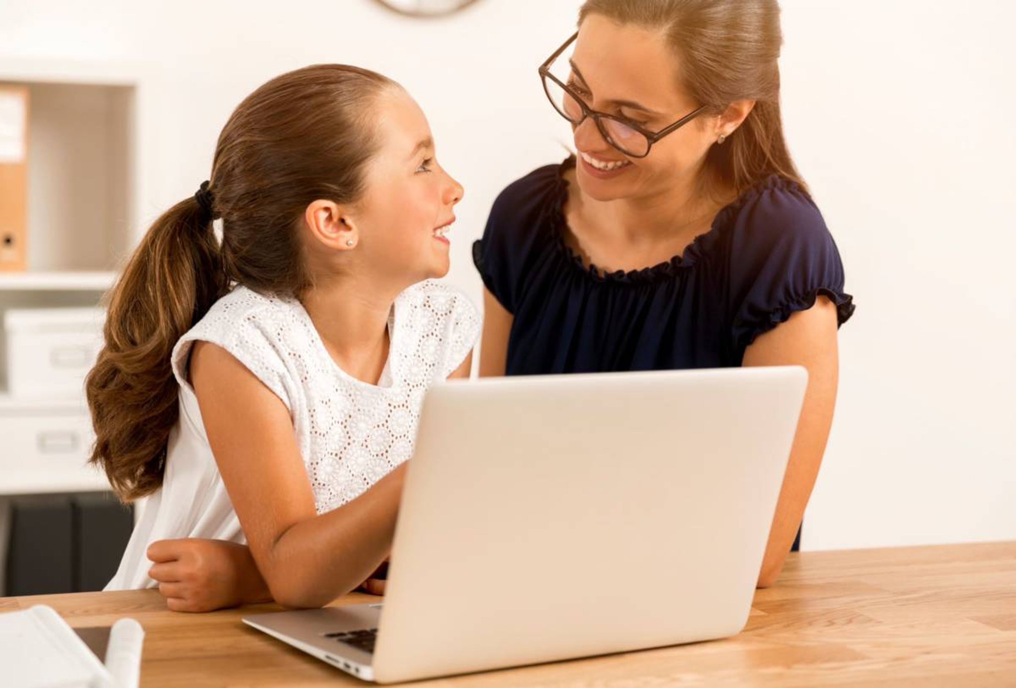 Mom and daughter in front of a computer answering questions