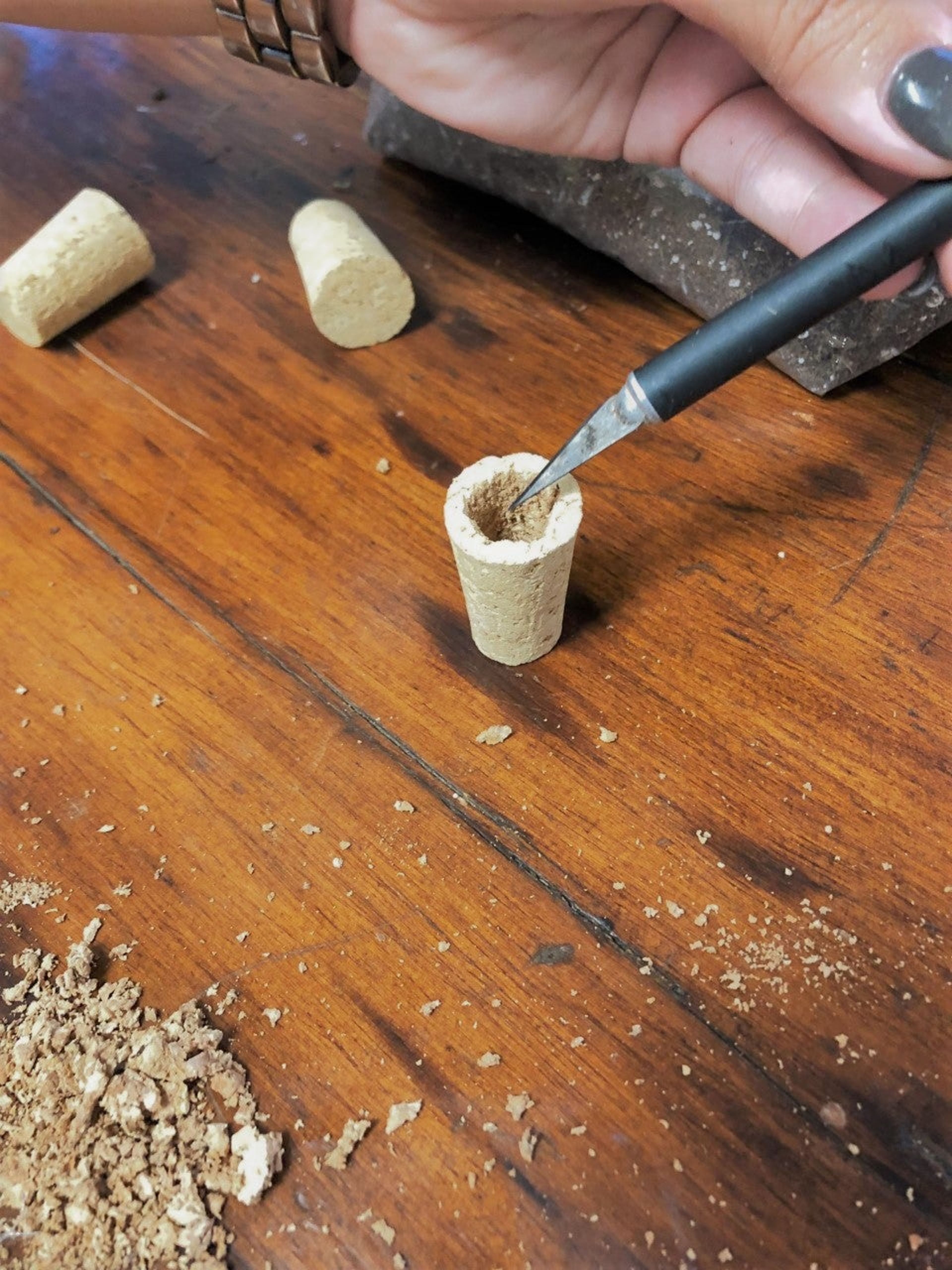 Hollowing out the center of the corks for DIY succulent magnets