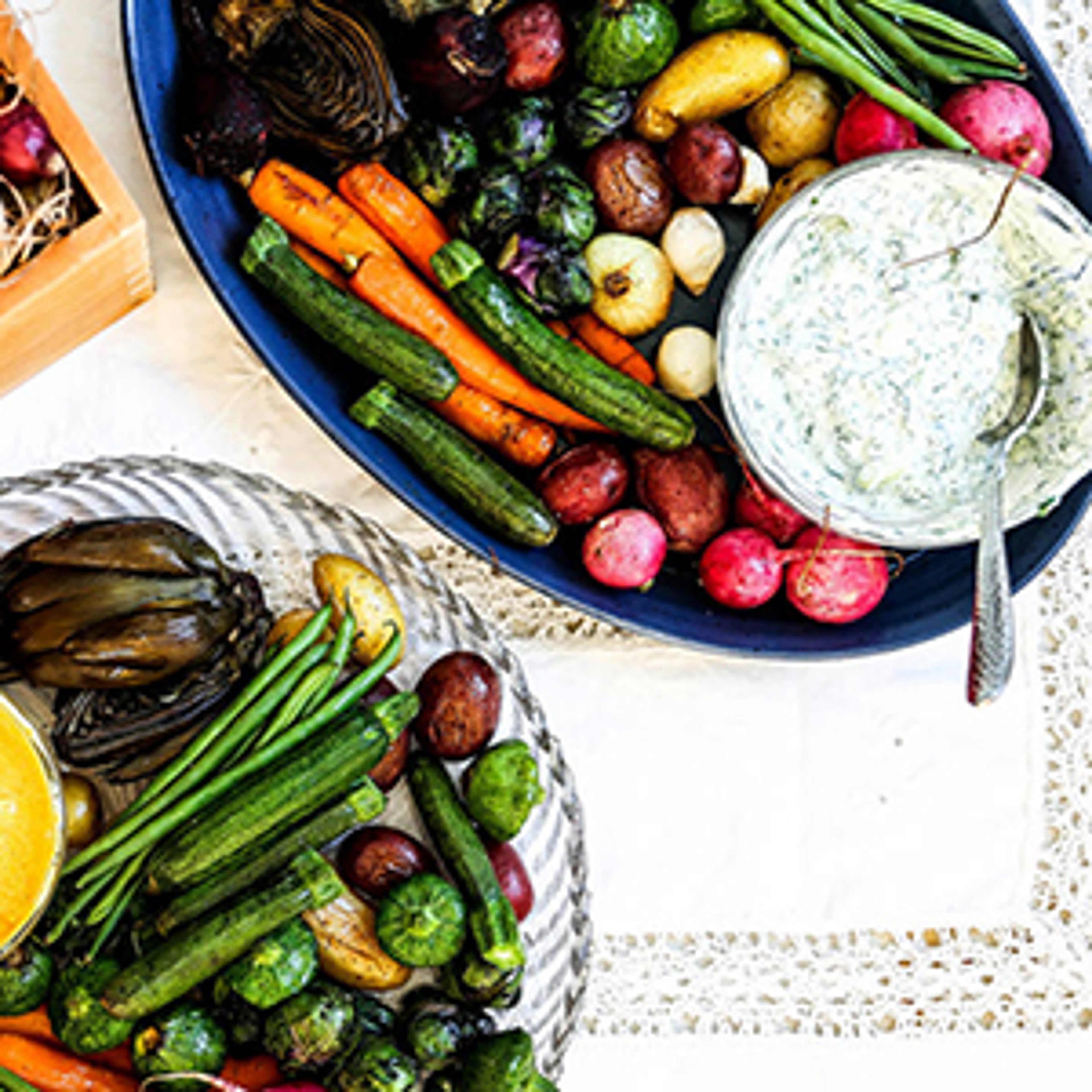 Roasted vegetables on platters with yogurt dip.