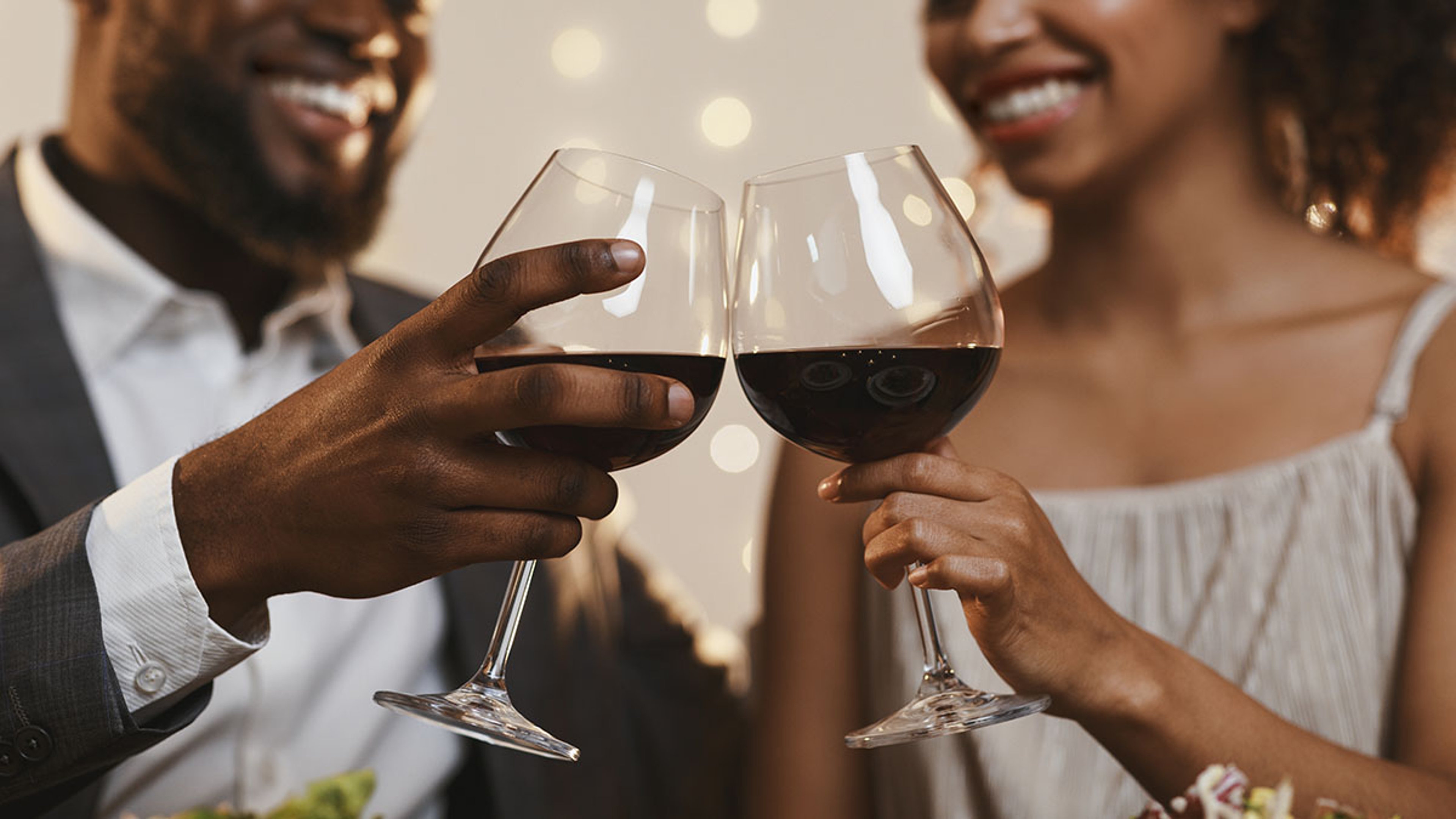 Article Cards Featured Image Close up of cheerful african american couple toasting with red wine, celebrating anniversary