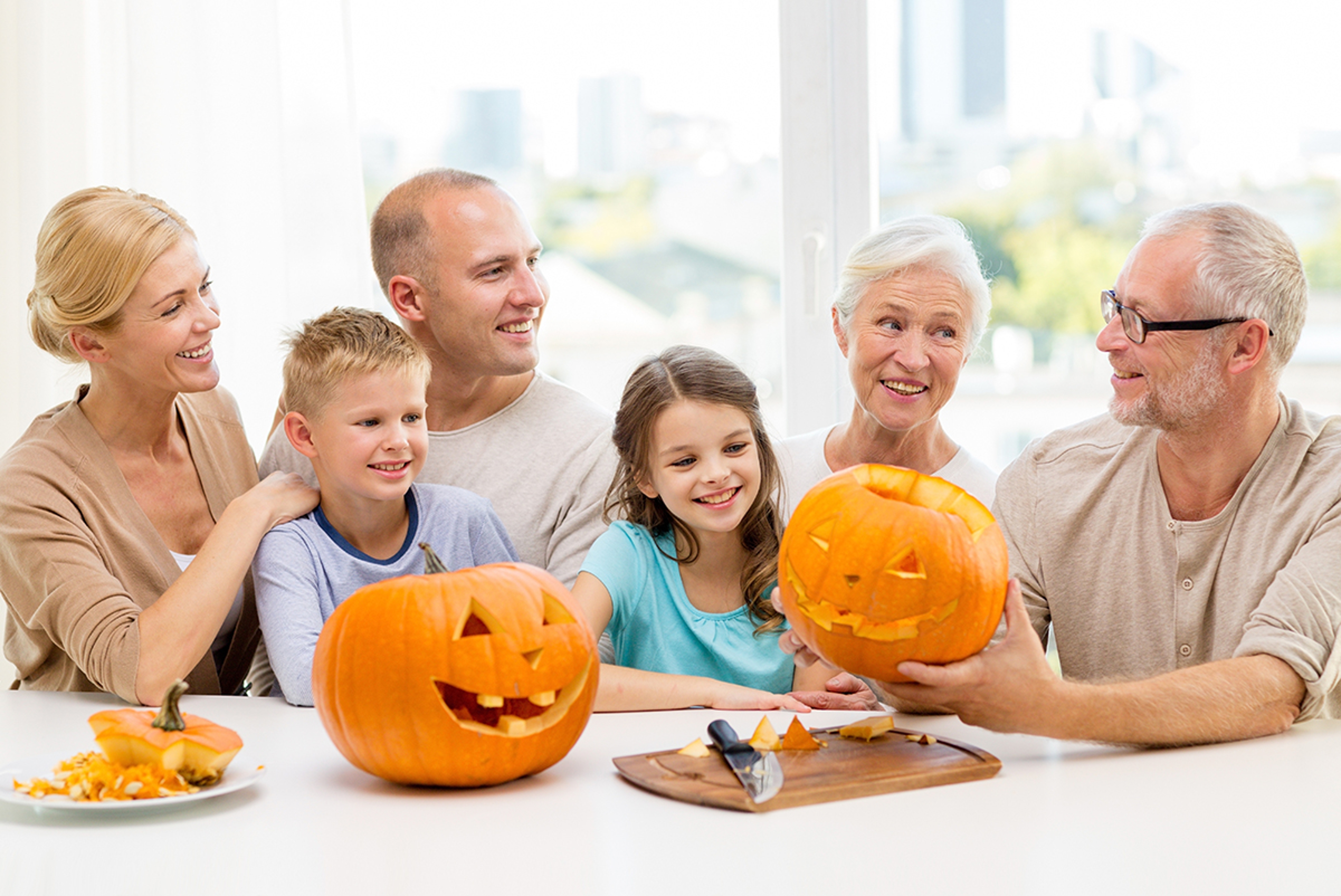 Article Cards Featured Image happy family sitting with pumpkins at home