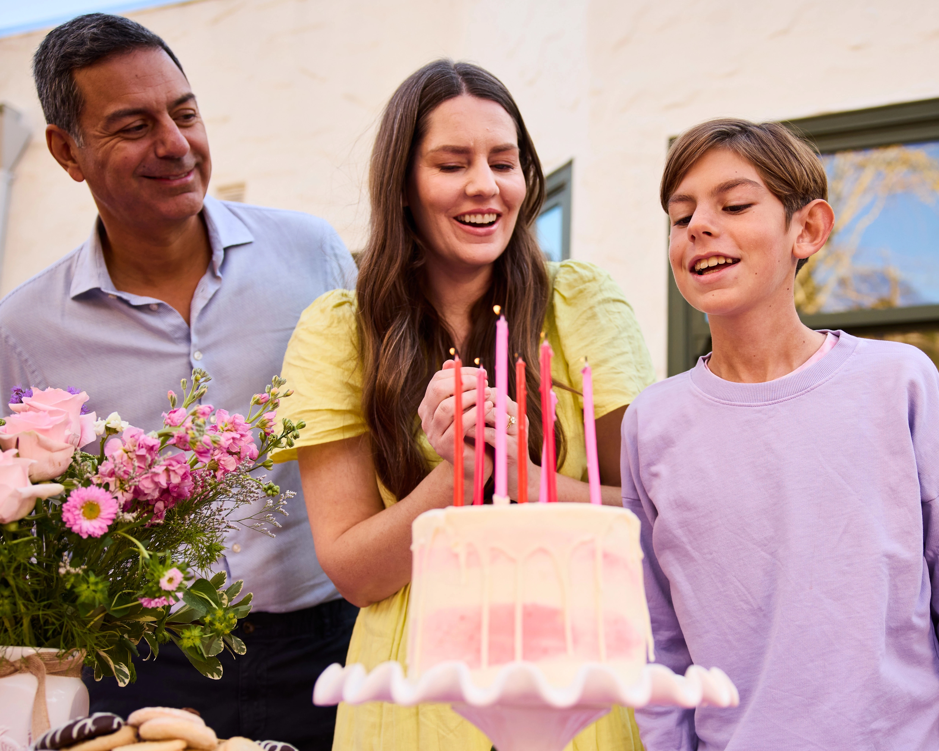 Birthday traditions with a child blowing out candles.