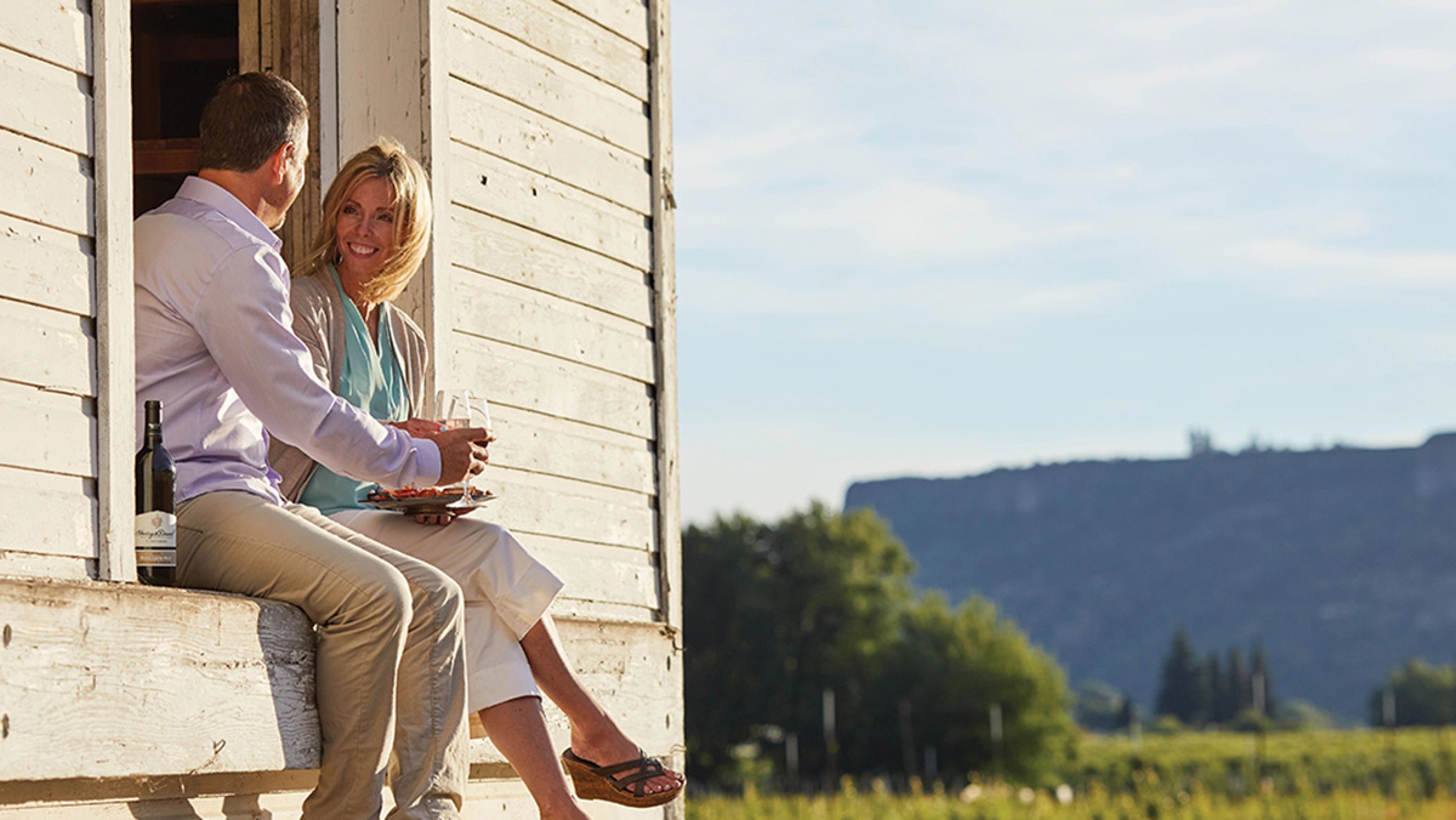 photo of a couple enjoying a glass of wine on a summer day