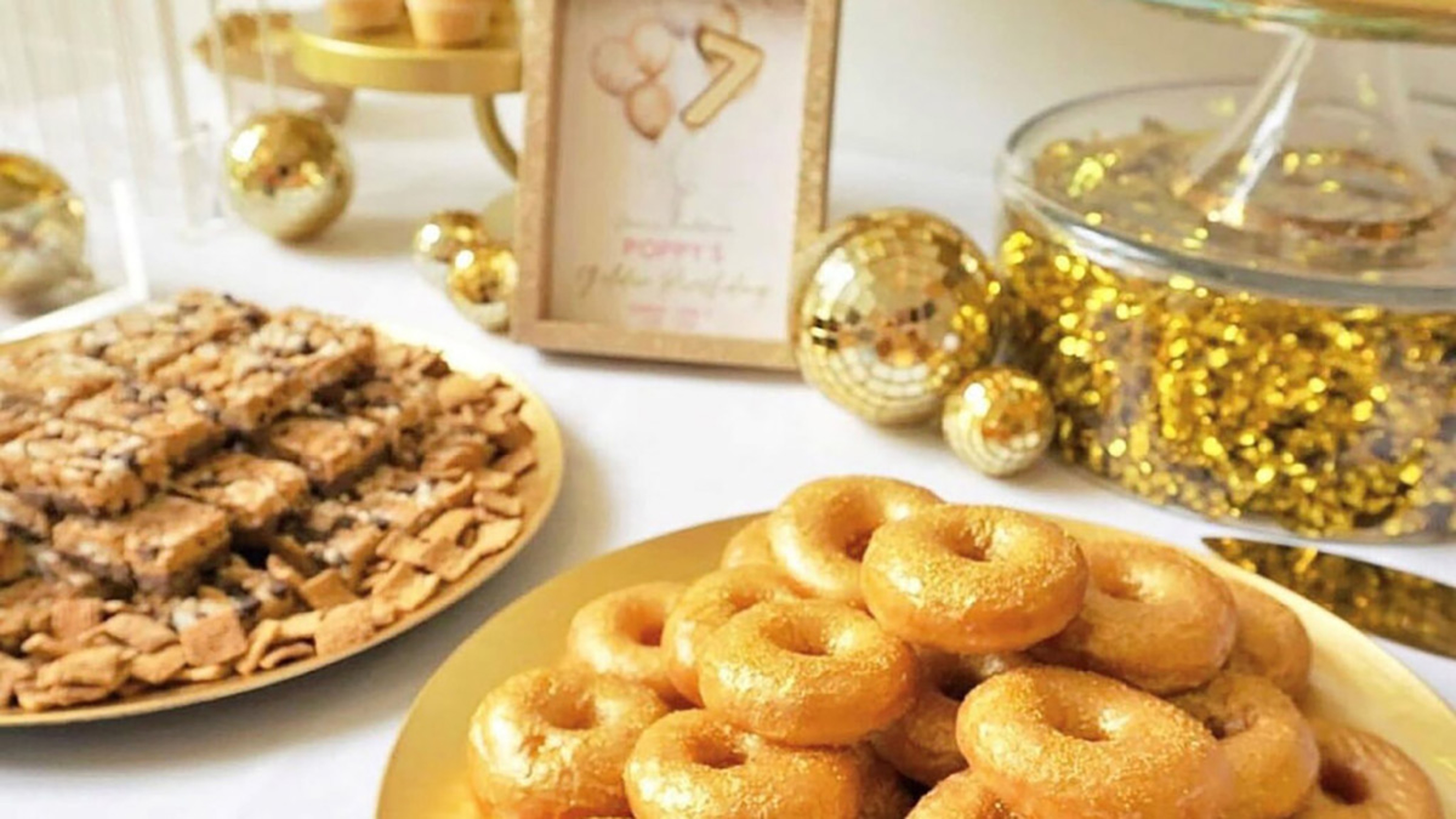 Golden birthday desserts and decorations.