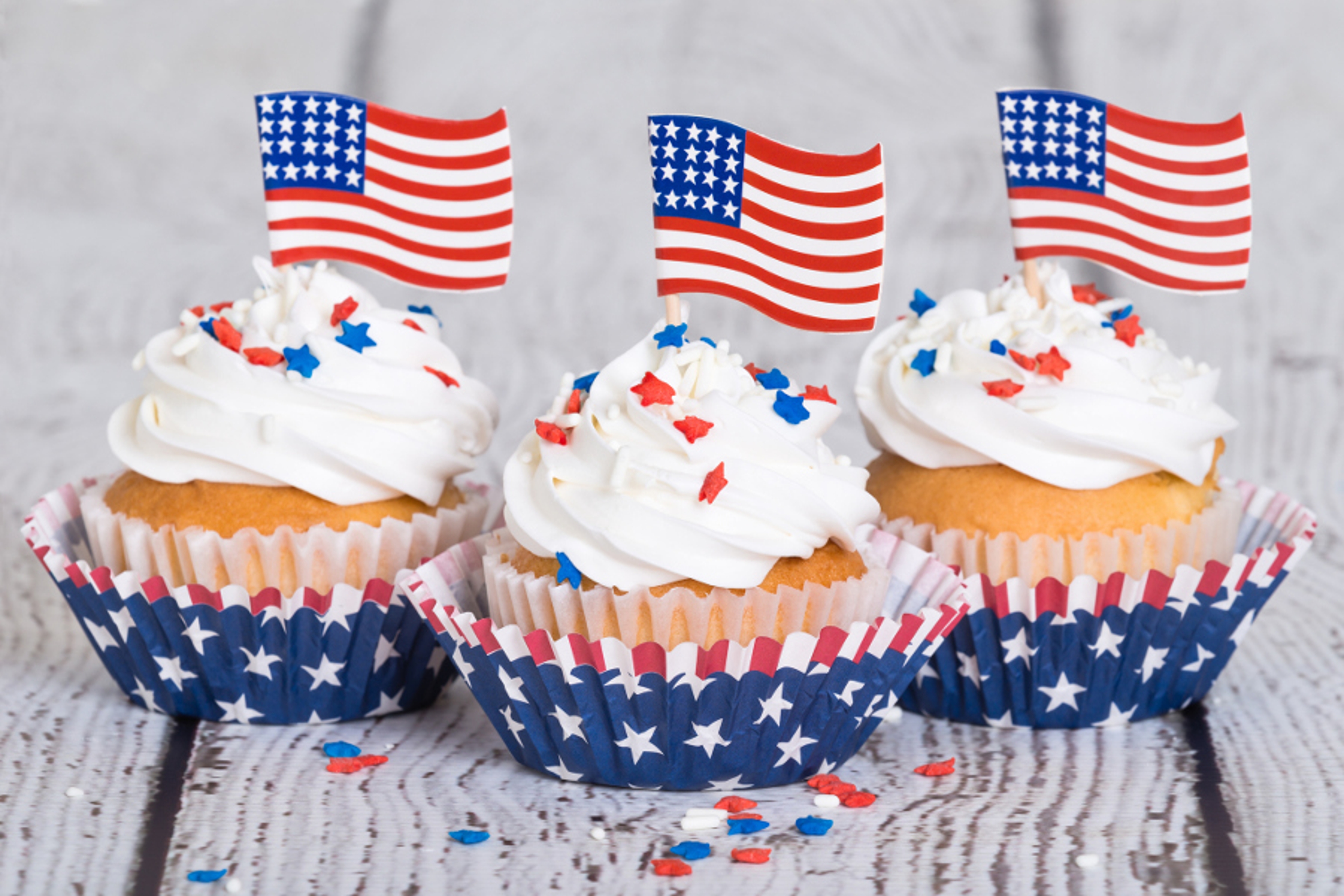 Article Cards Featured Image Patriotic cupcakes with sprinkles and American flags on vintage background