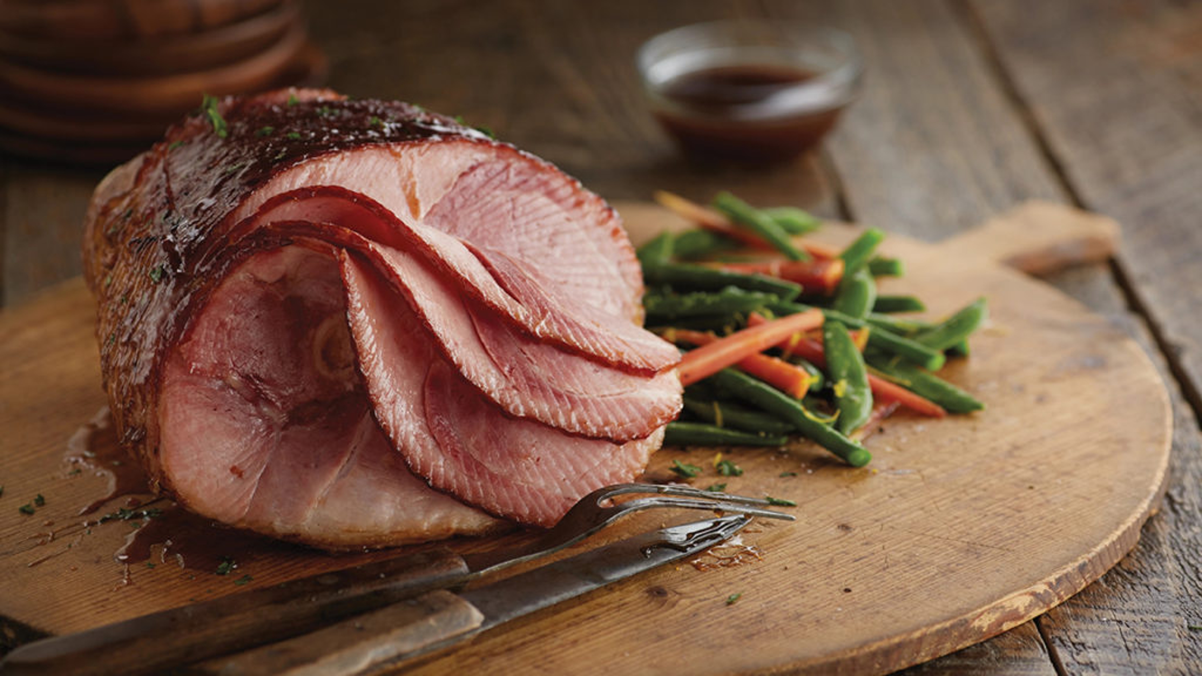 Easter ham on a cutting board.