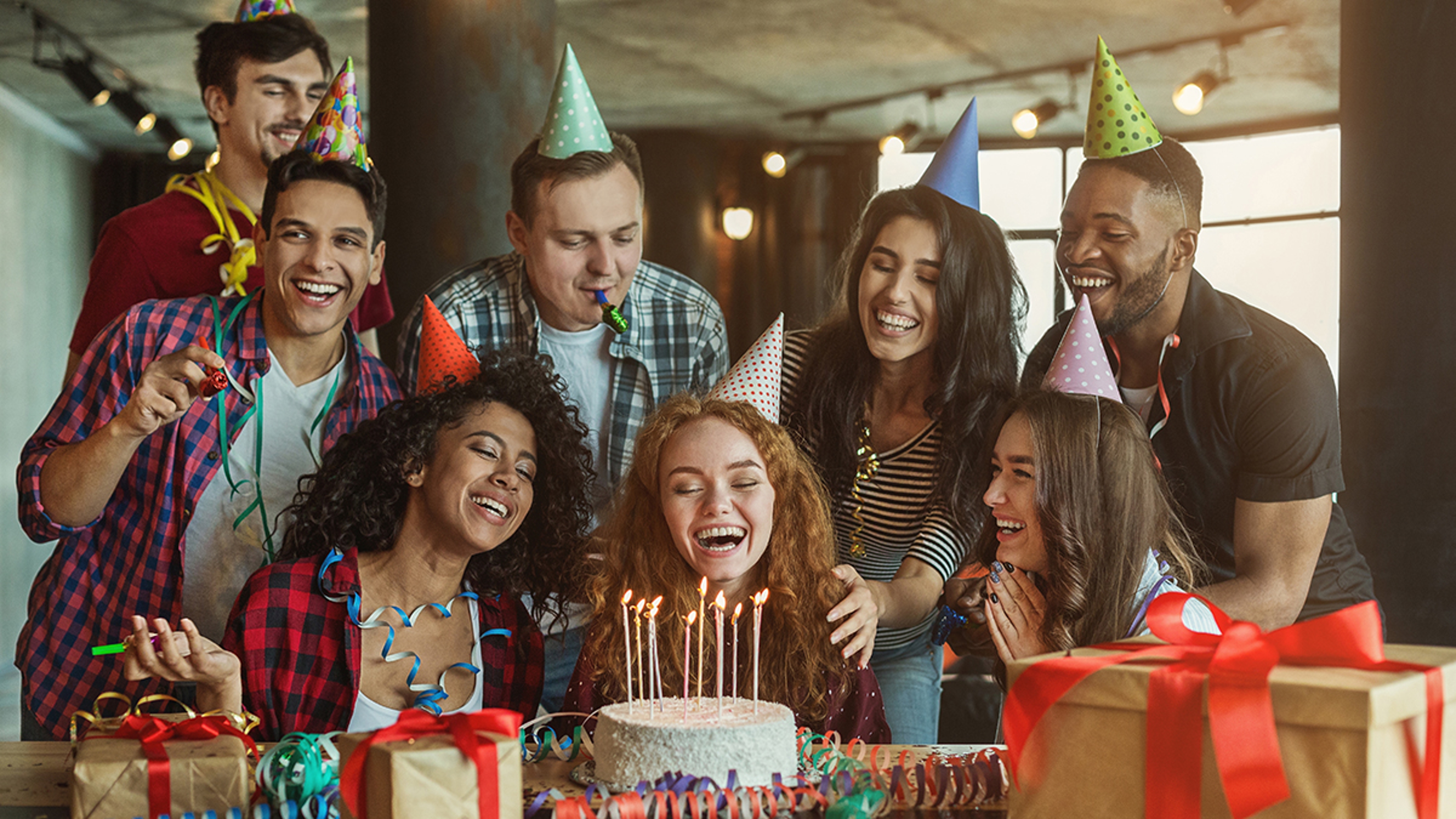 Friends presenting birthday cake to girl