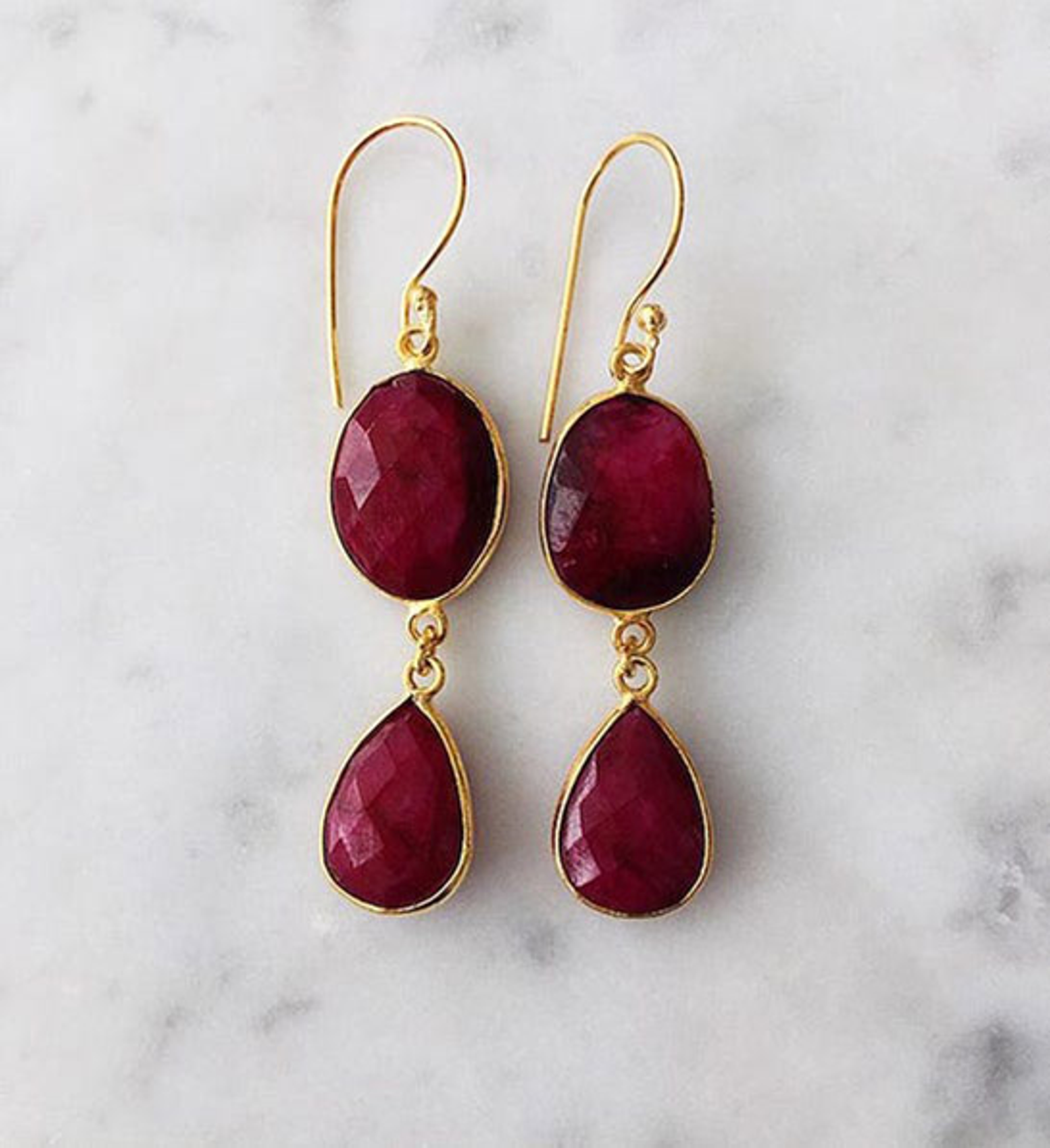 anniversary gift guide image ruby earrings with a marble background