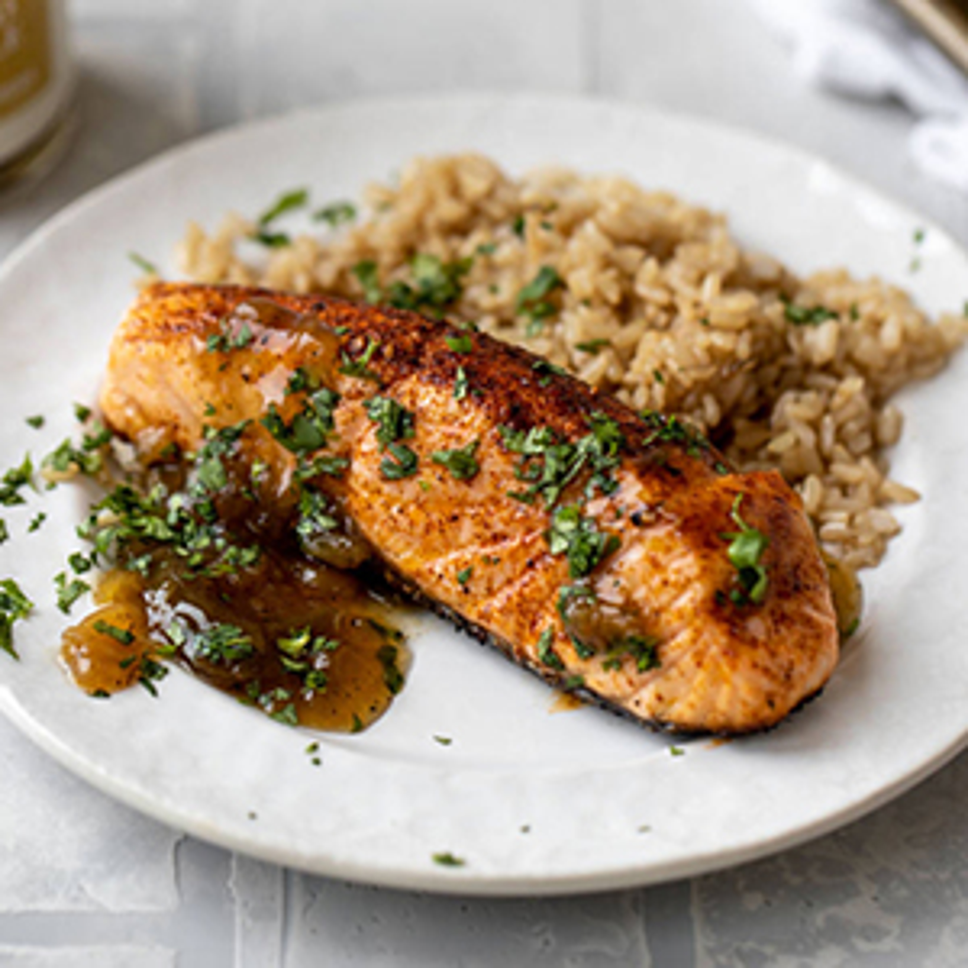 Plate of cooked salmon with pineapple relish and rice.