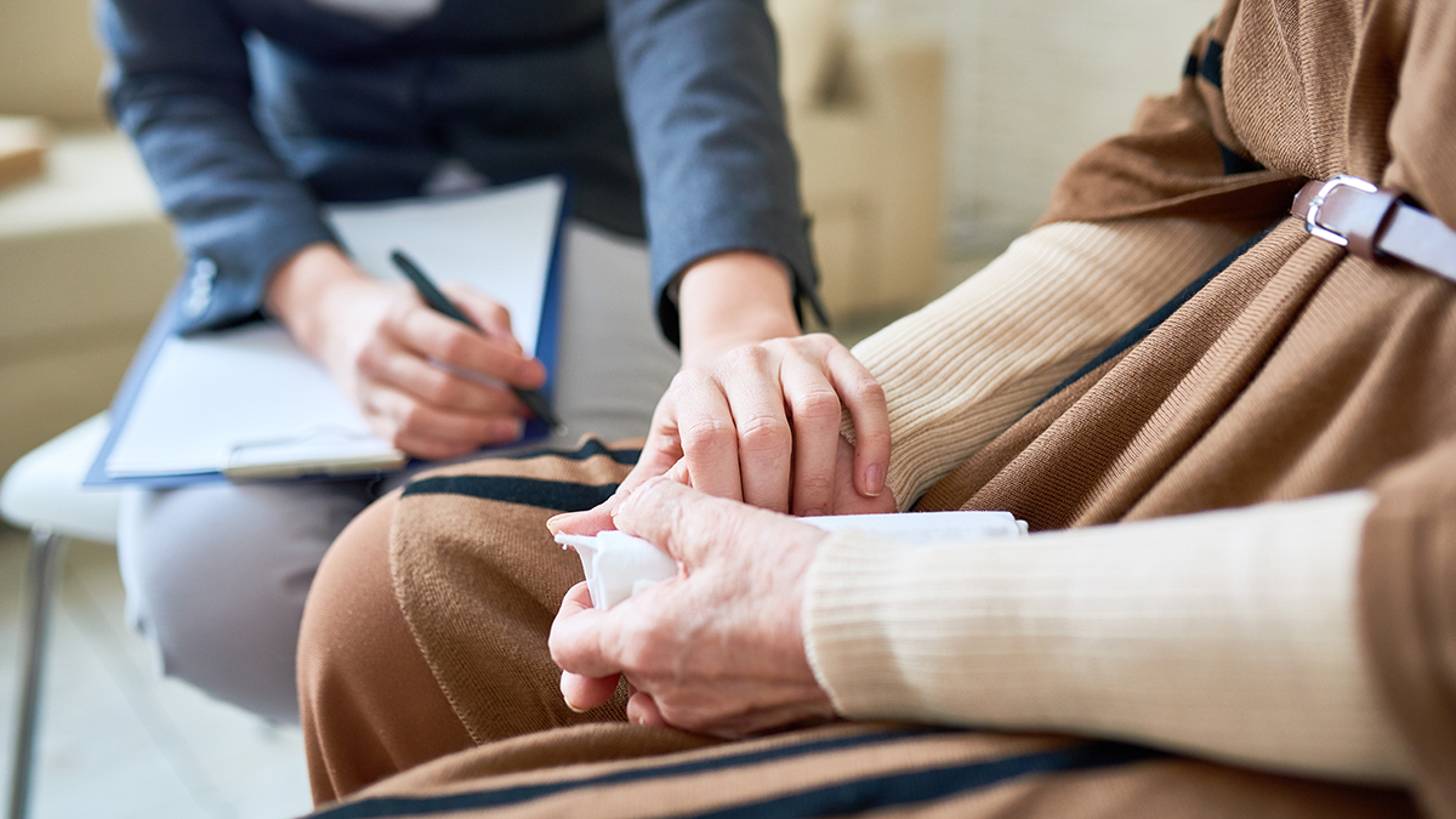 Grief overload with a therapist and patient sitting in chairs.