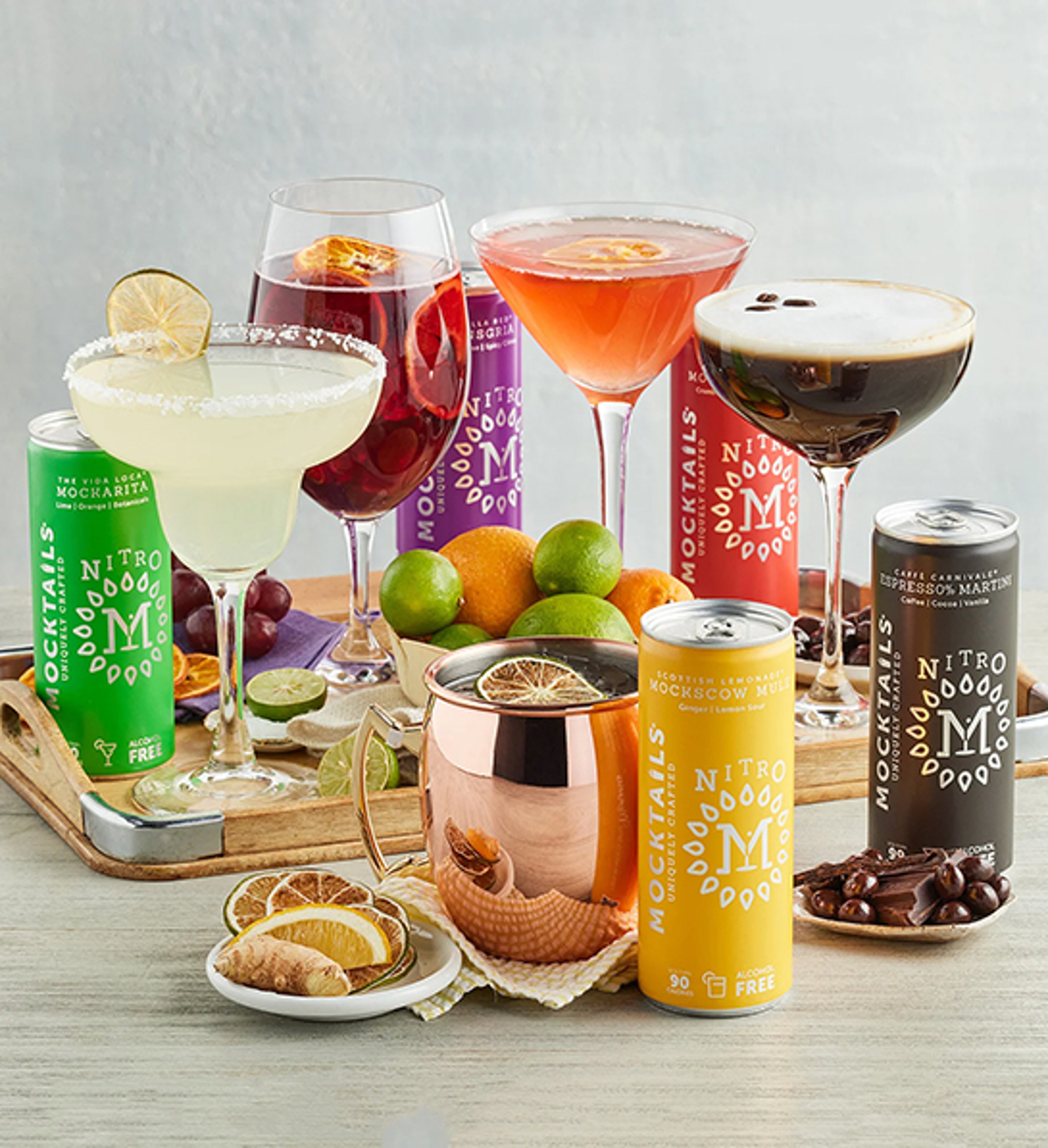 Home bartender with several mocktails on a countertop.