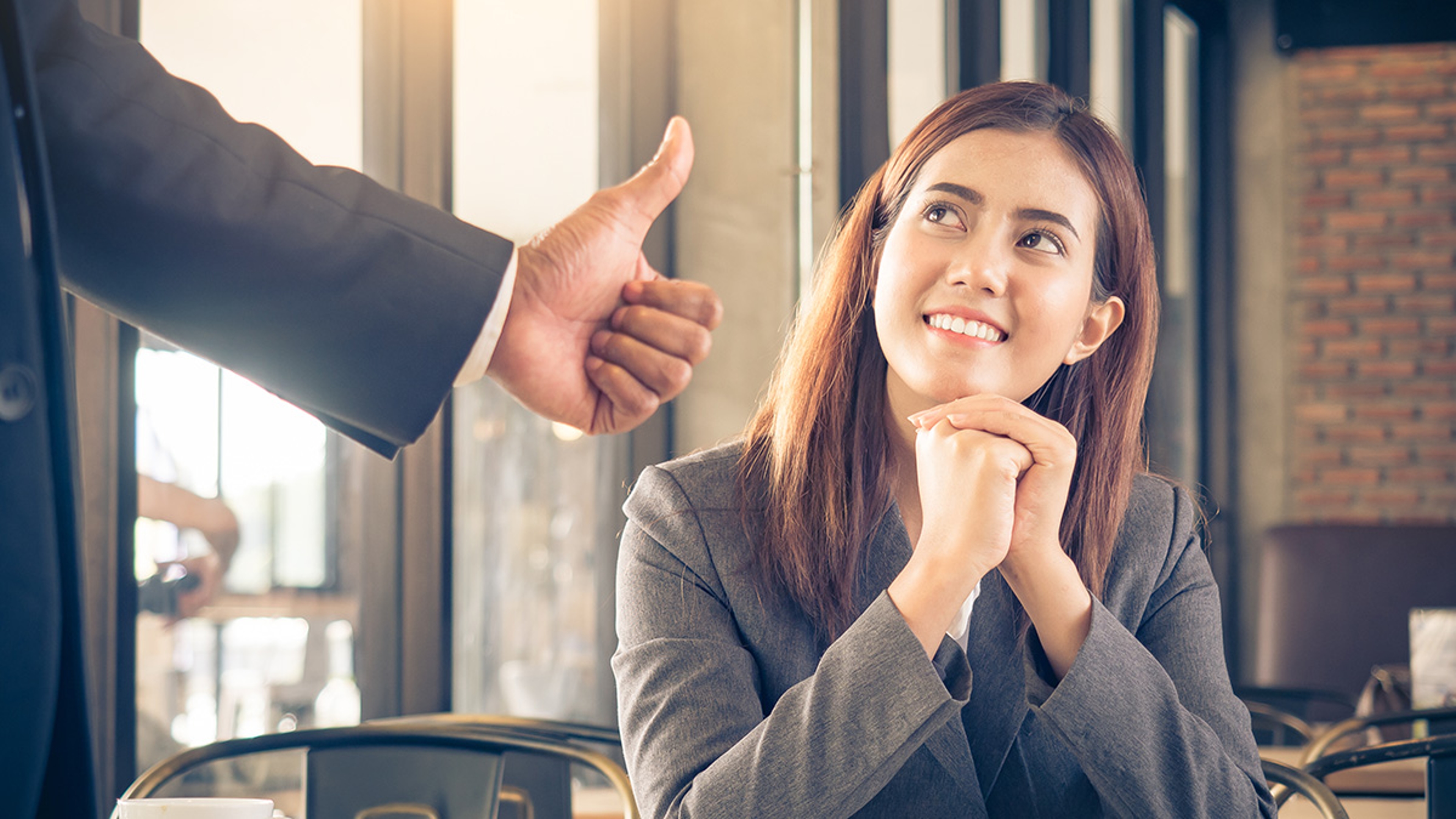 Article Cards Featured Image boss showing an employee appreciation by giving her a thumbs up