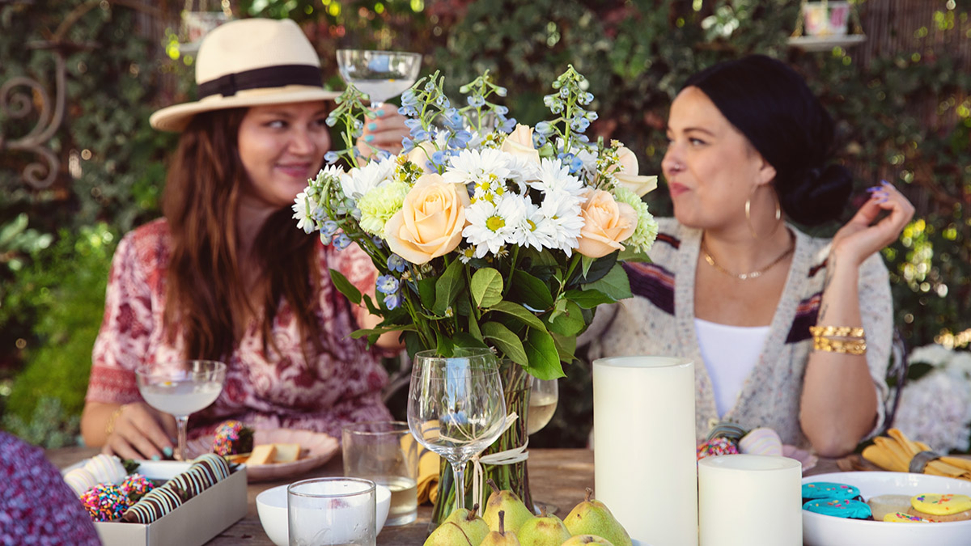 Article Cards Featured Image Two women outside having a garden party while toasting glasses Garden Party Ideas