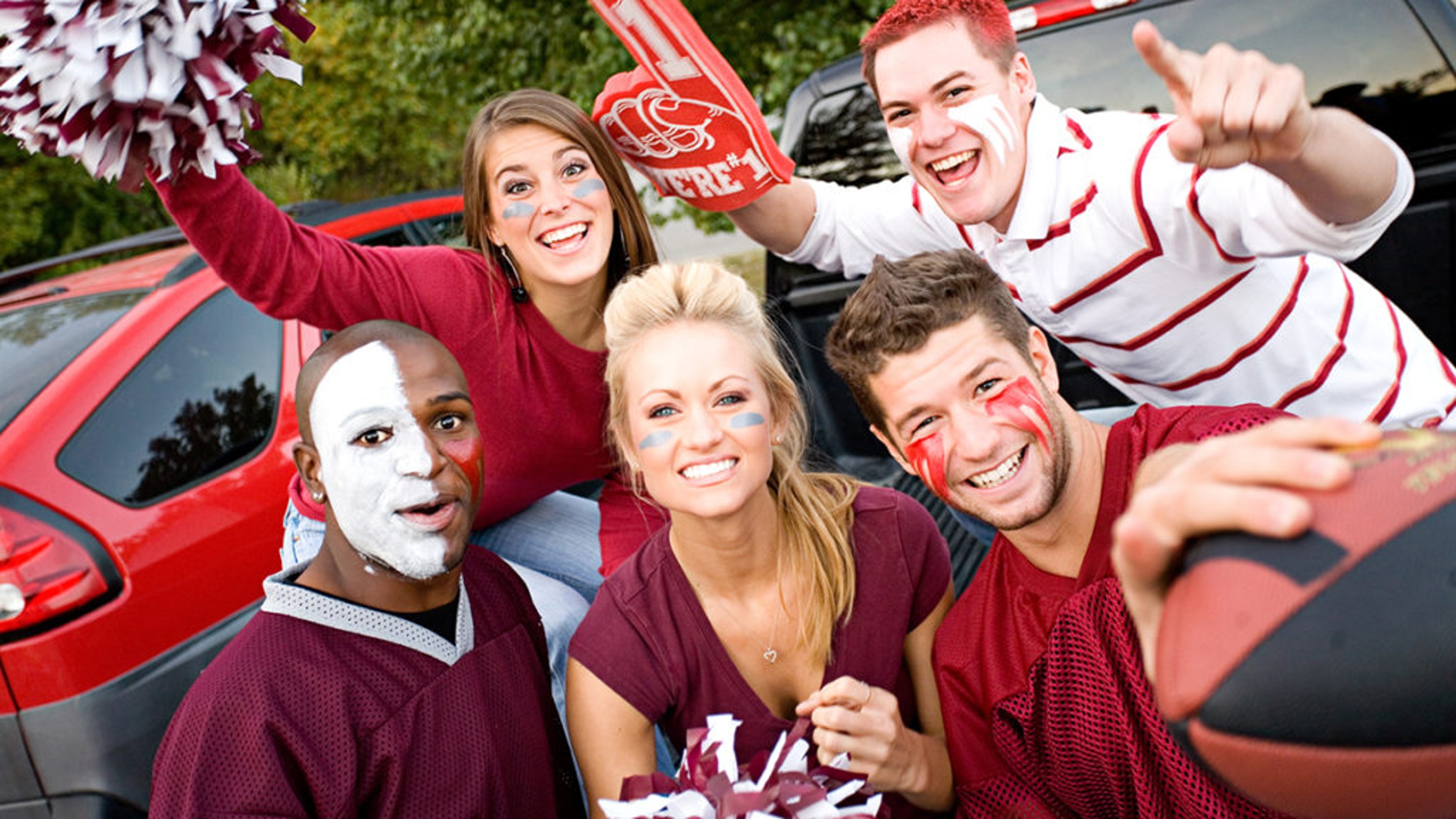 Group of people at a tailgate party.