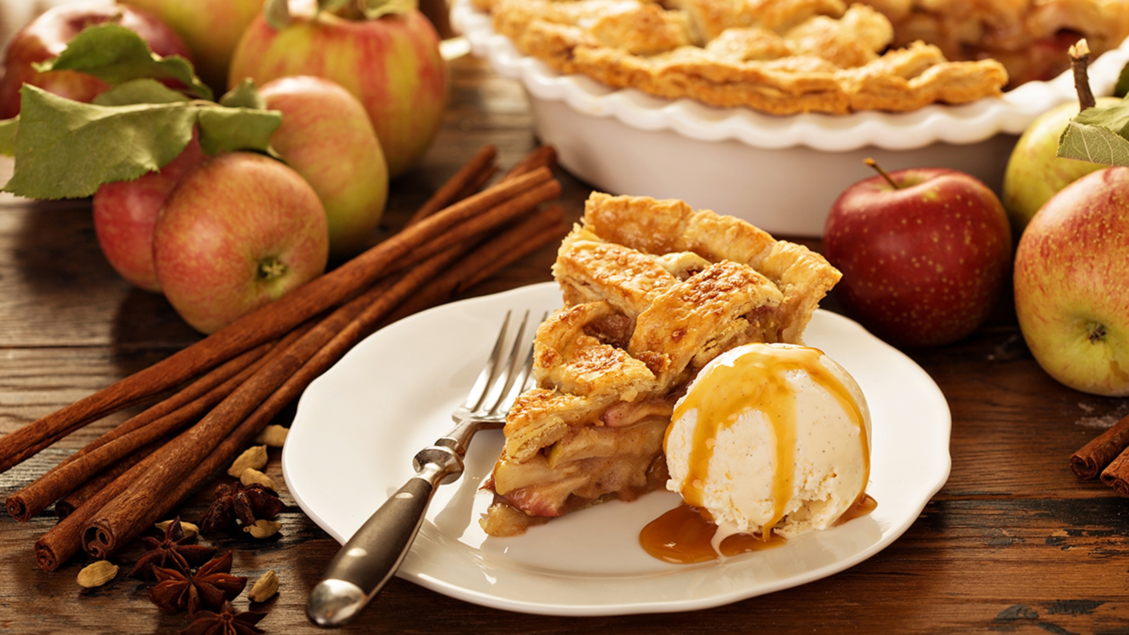 Slice of apple pie with a scoop of ice cream.