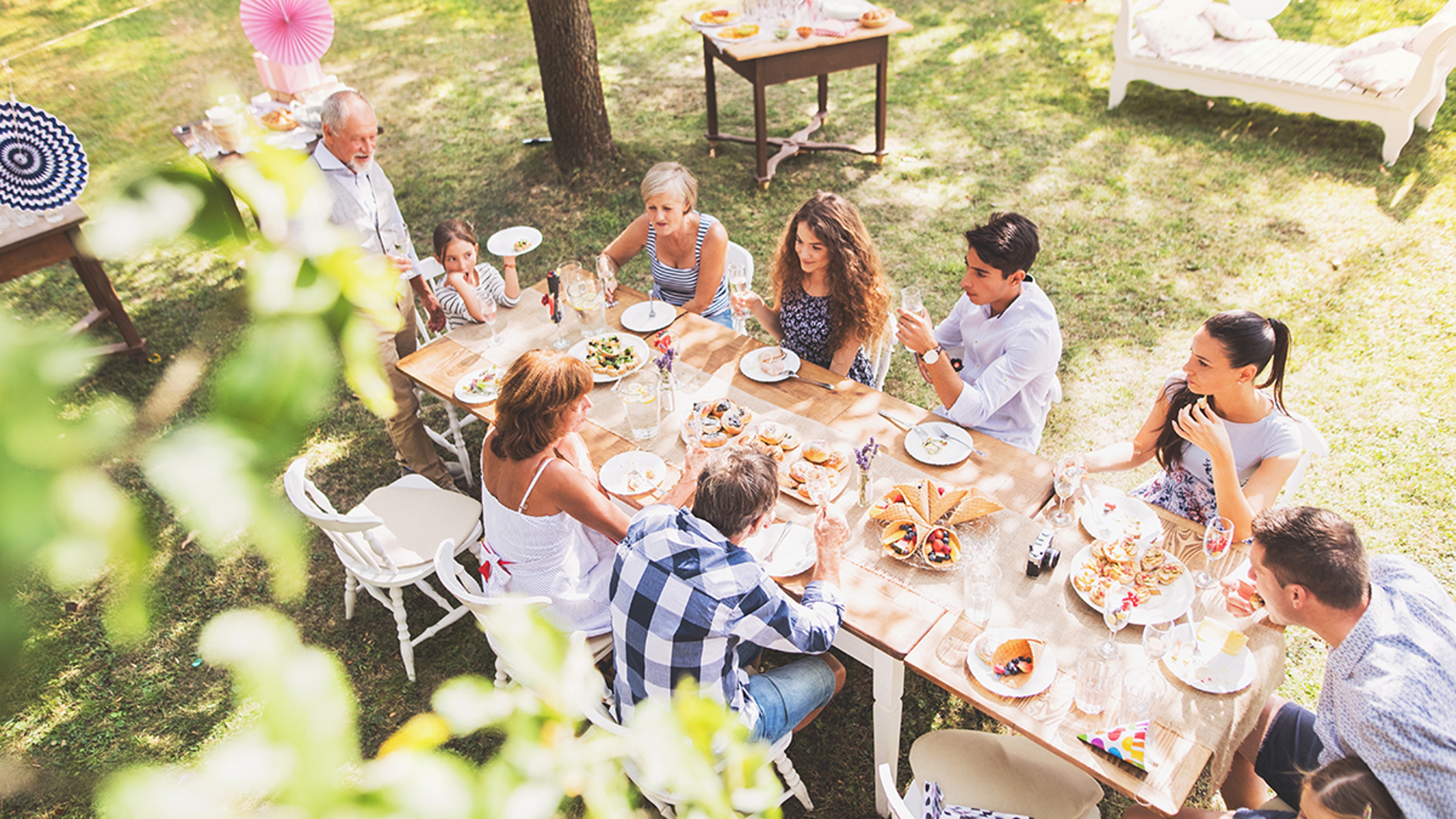 Article Cards Featured Image Family celebration or a garden party outside in the backyard.