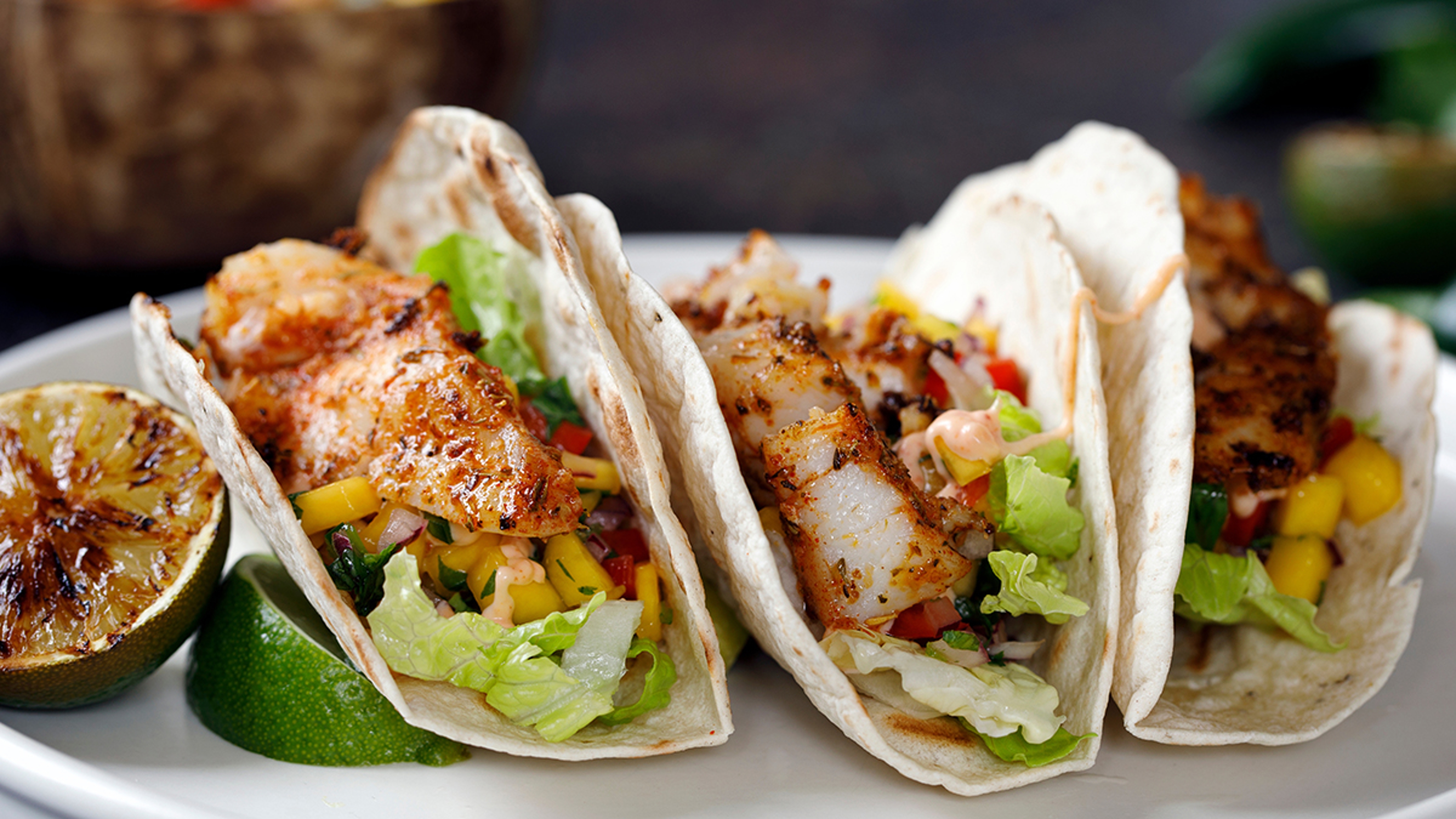 Grilling recipes with three fish tacos on a plate.