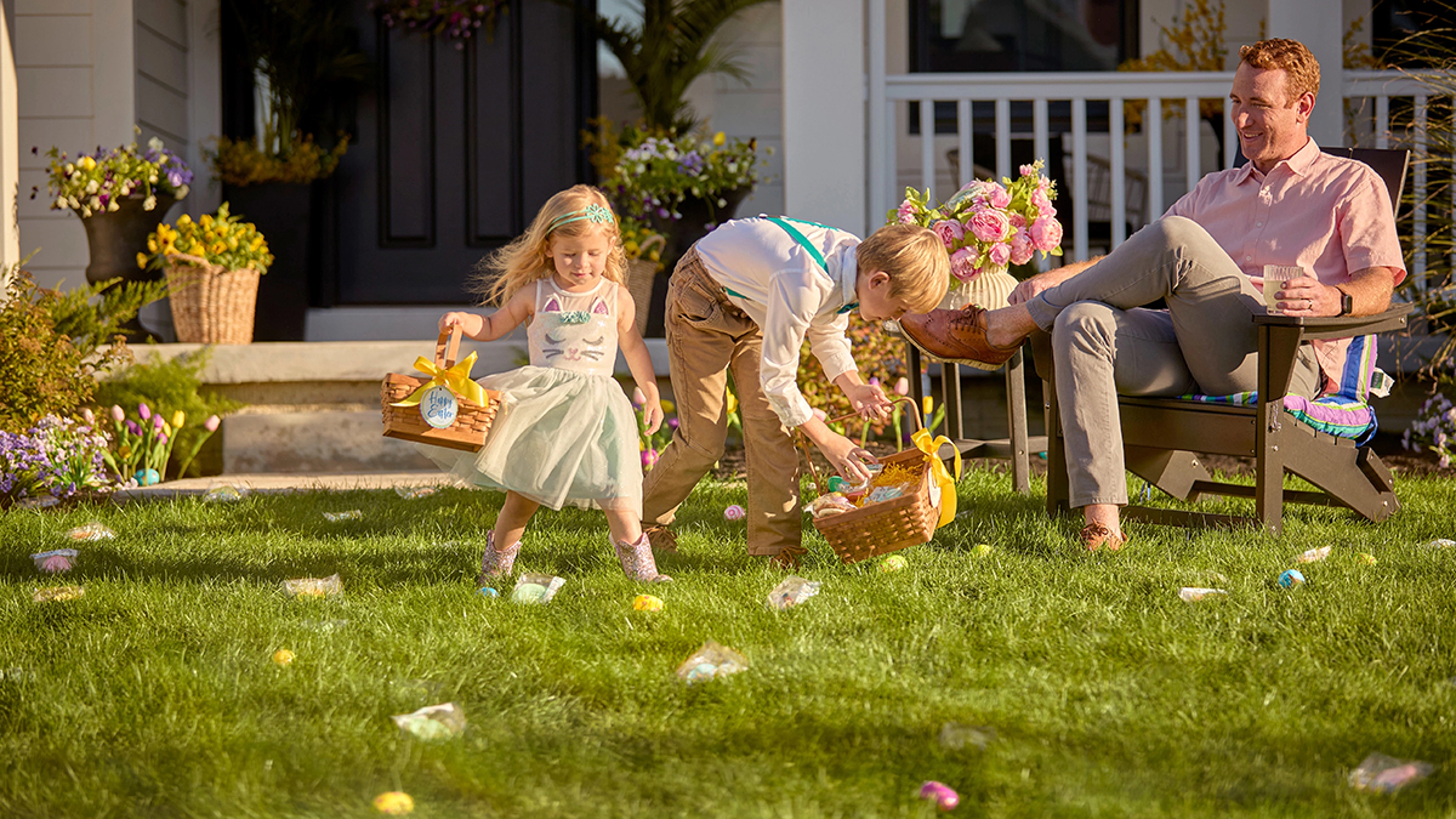 Easter egg hunt ideas with two children finding eggs in the grass.