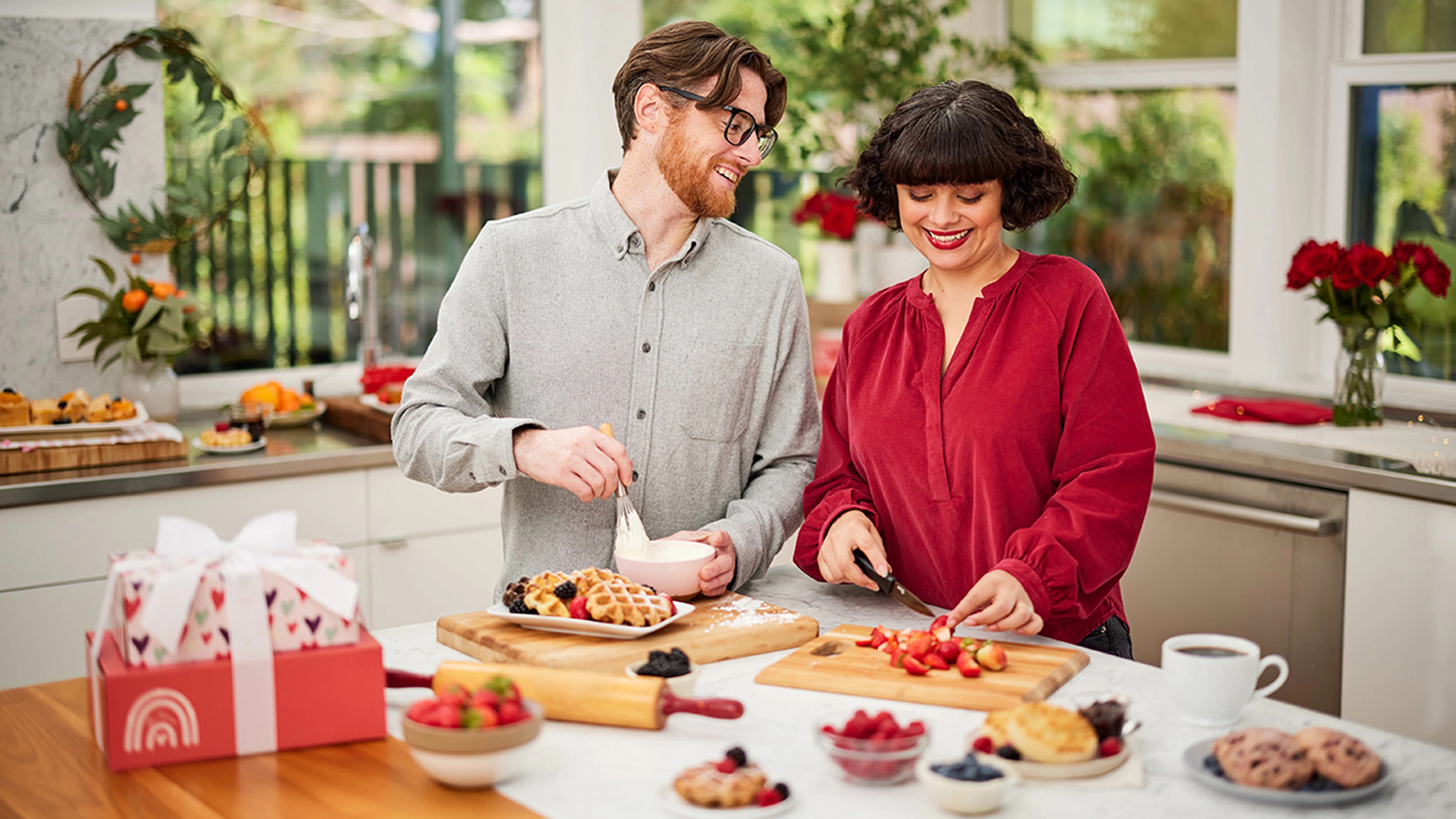 valentines day gifts by relationship length couple prepping food in the kitchen