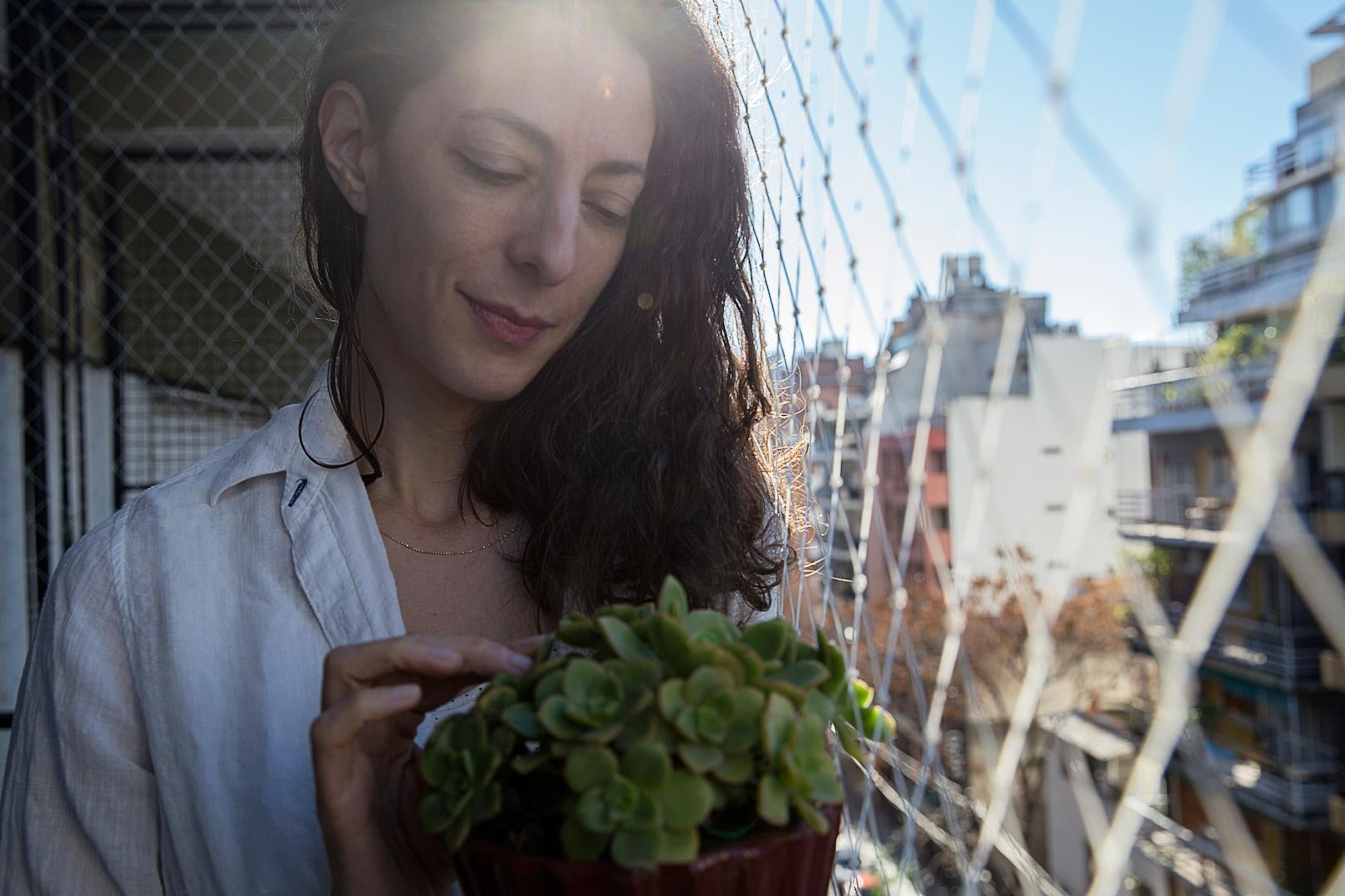 Article Cards Featured Image woman holding plant in shade in fall