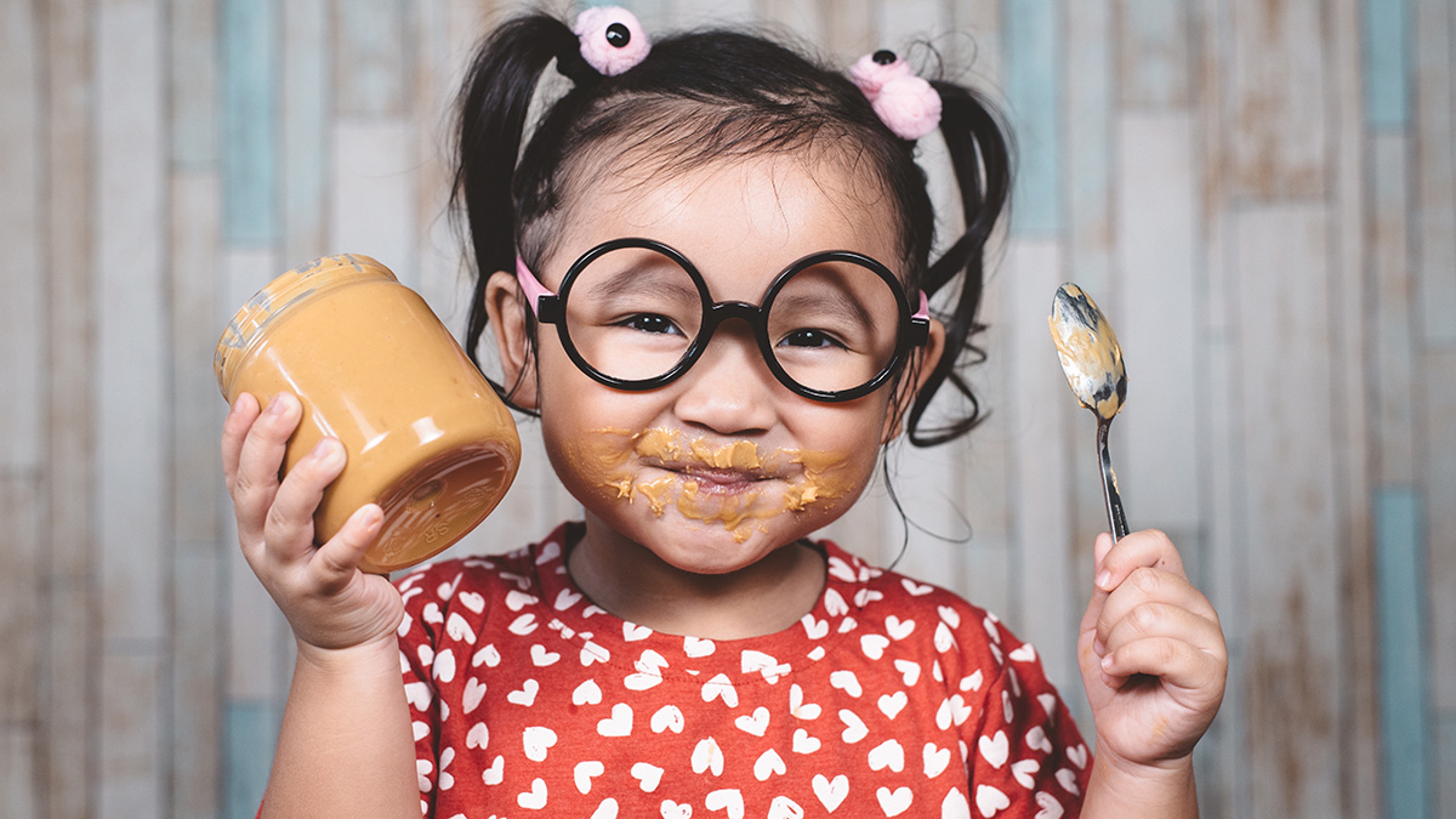 Article Cards Featured Image girl eating peanut butter