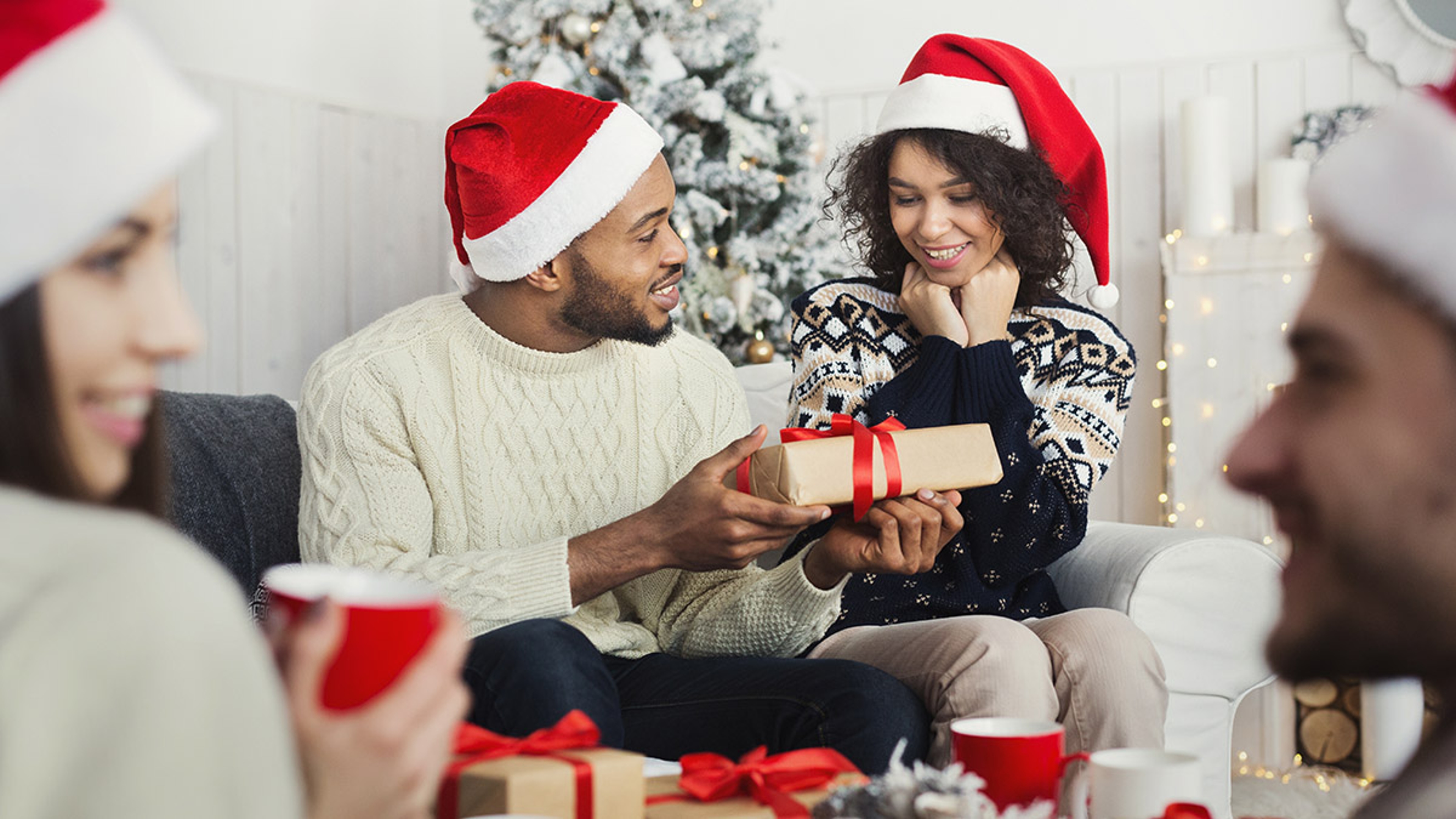 Article Cards Featured Image man surprising woman with Christmas gift