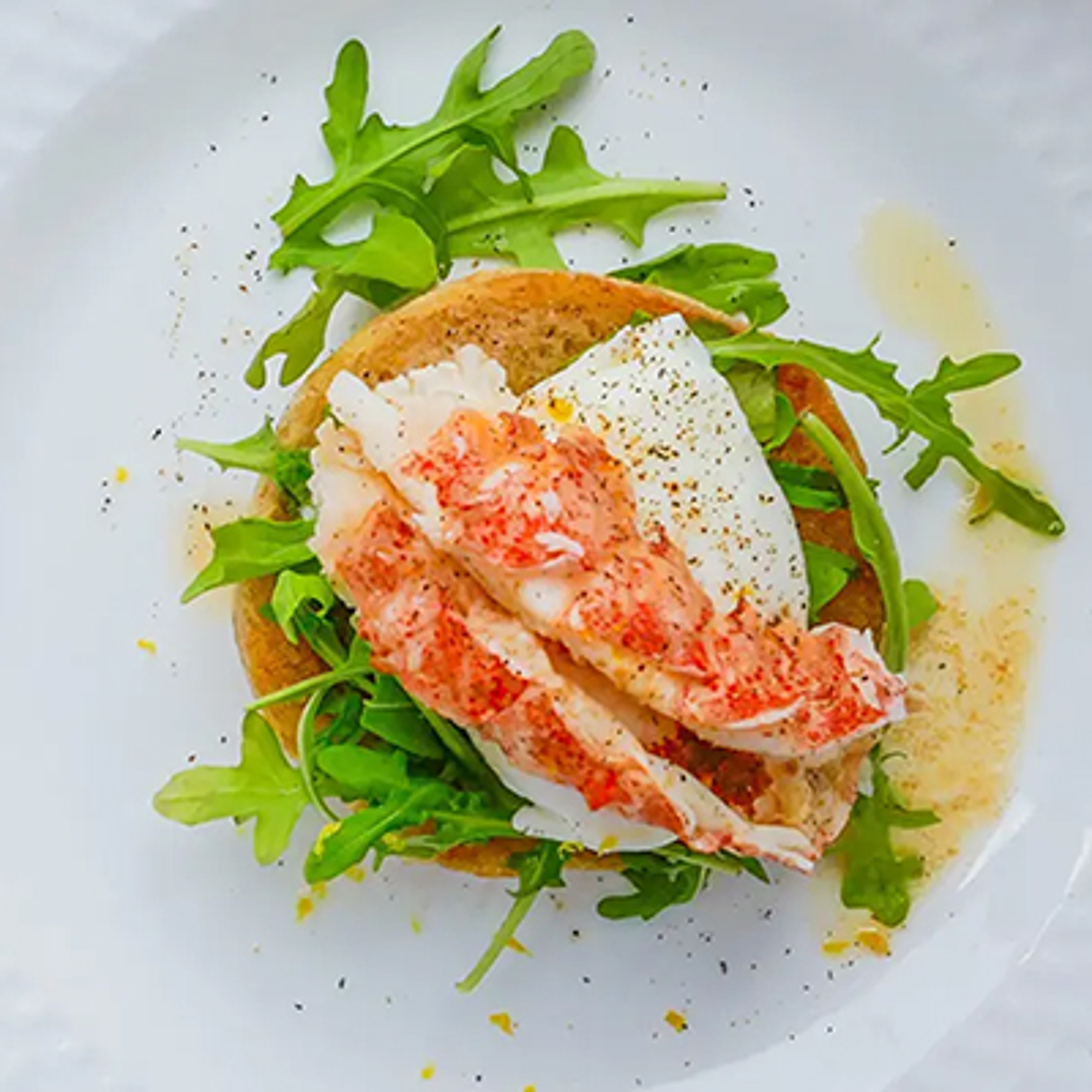 Lobster eggs Benedict with arugula