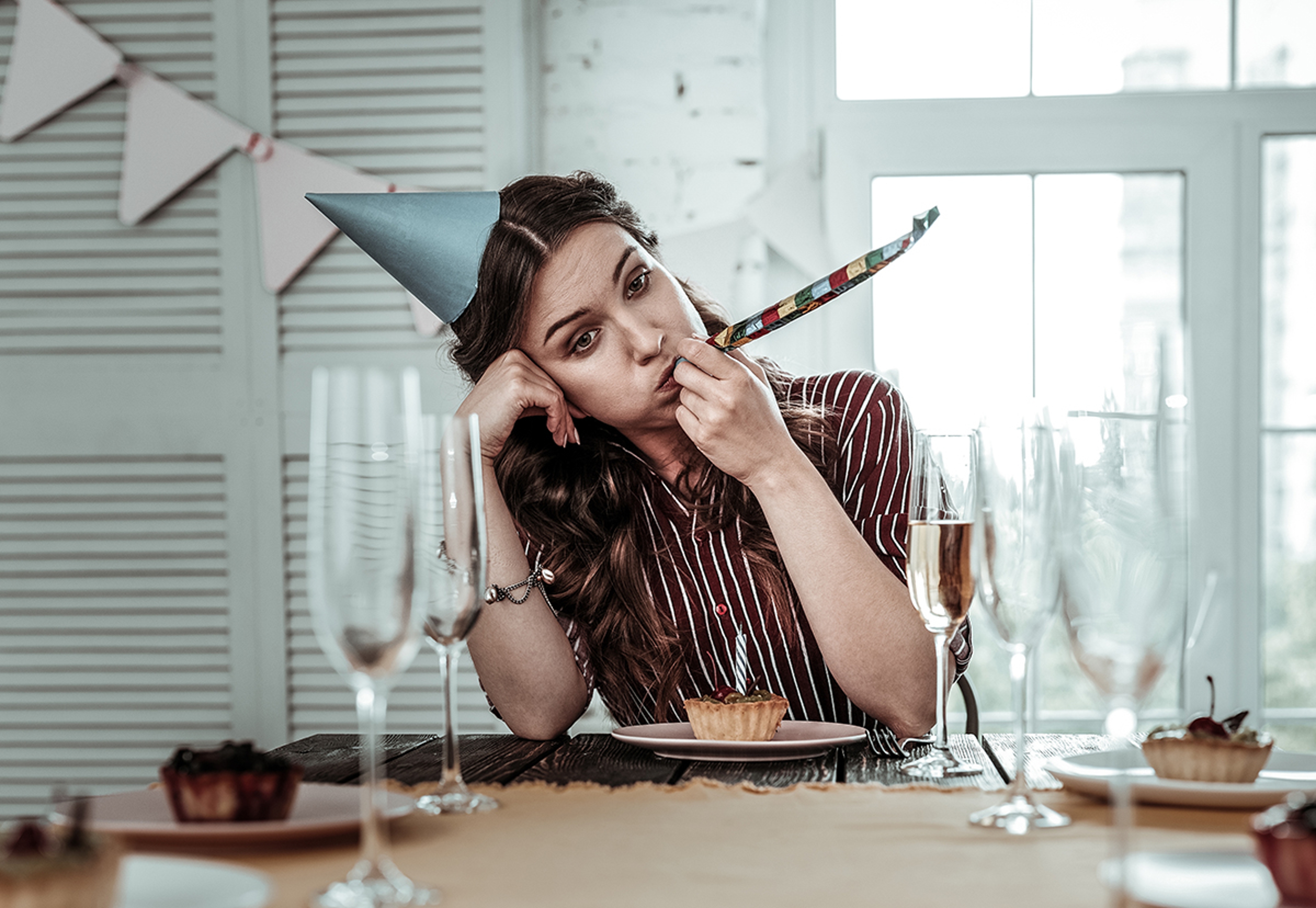 Article Cards Featured Image Upset drunk woman celebrating her birthday party alone