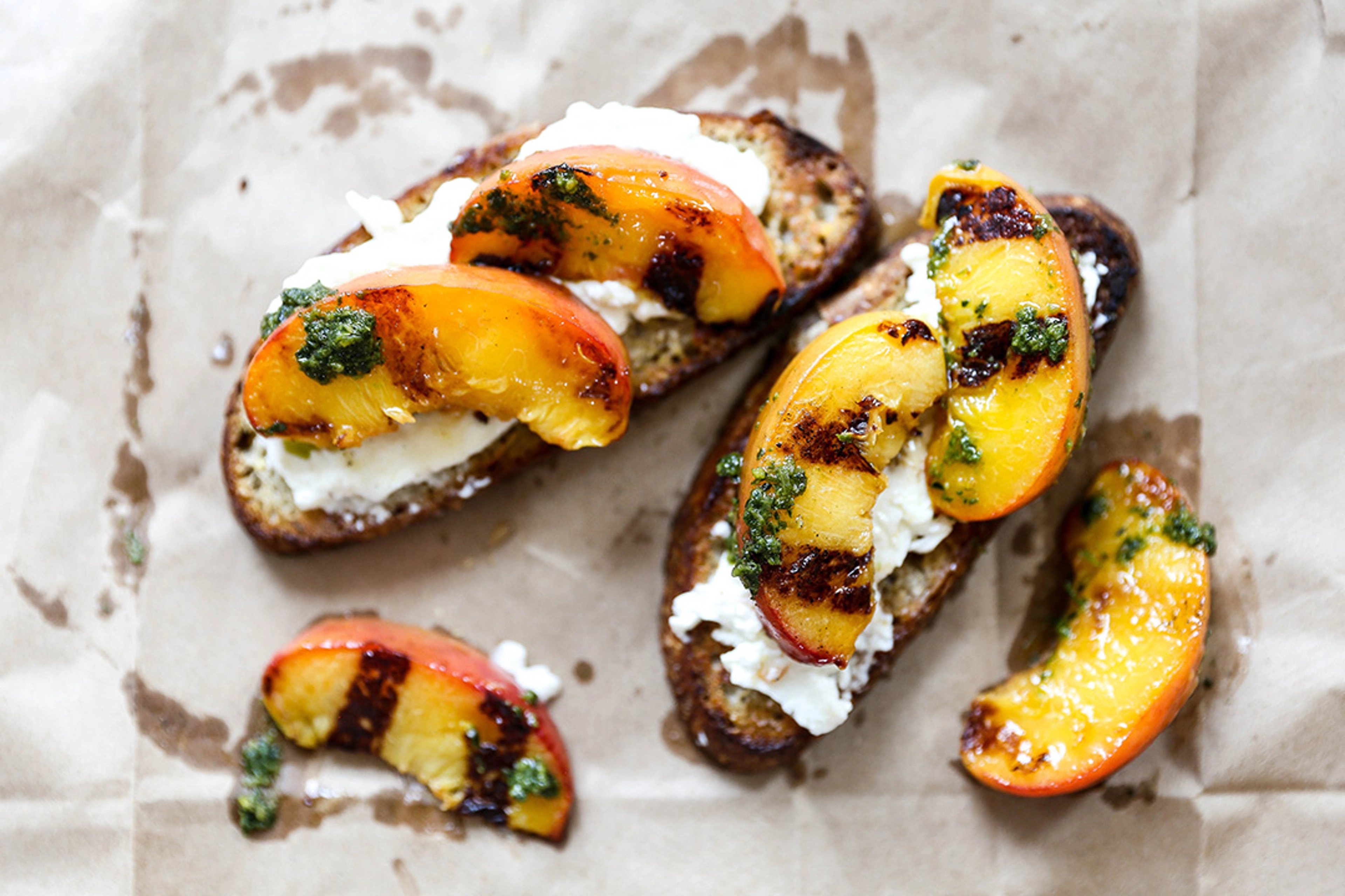 Grilled peaches with burrata and pesto on toast.
