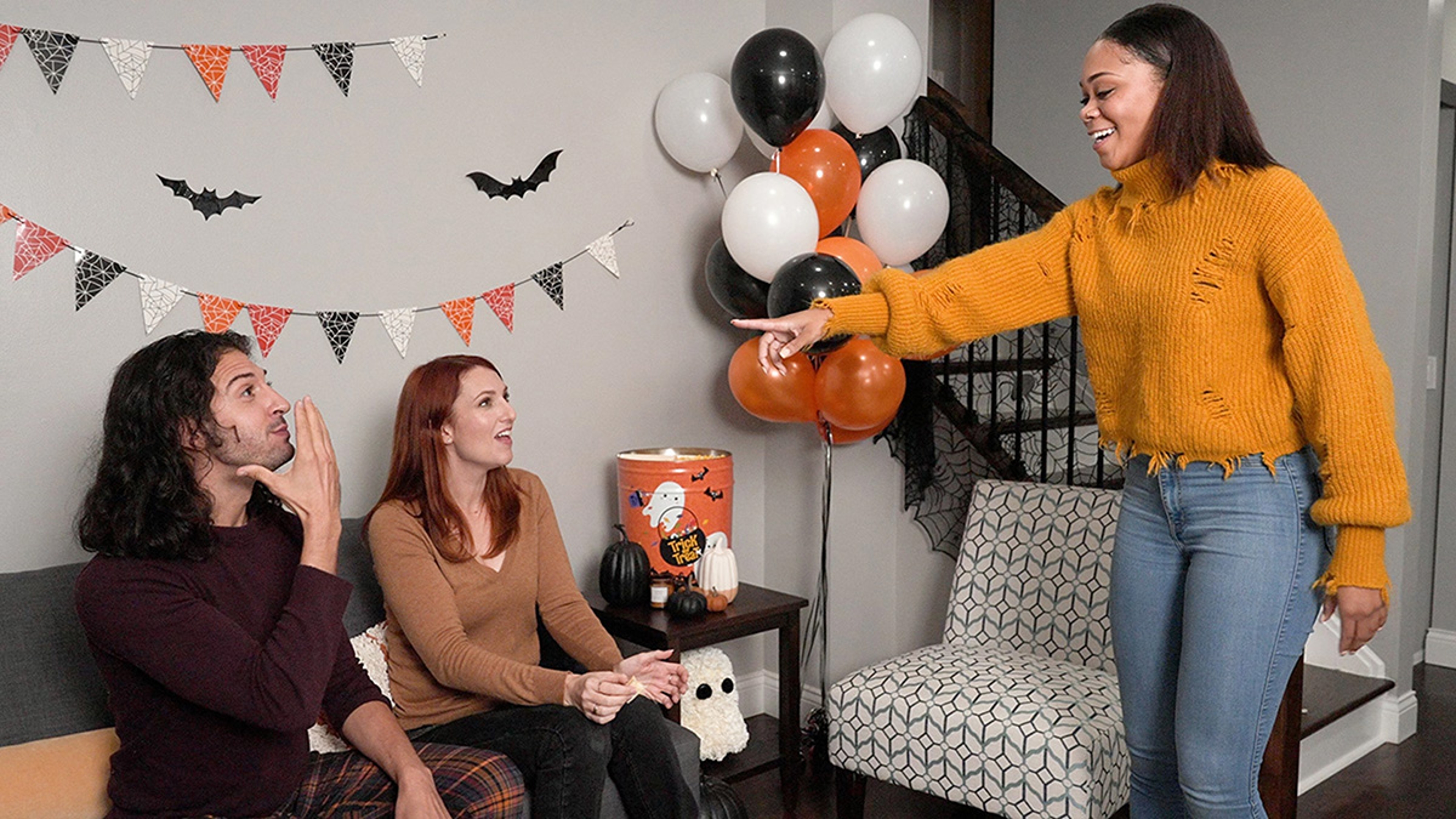 Group of friends celebrating a fall birthday party with a Halloween theme.