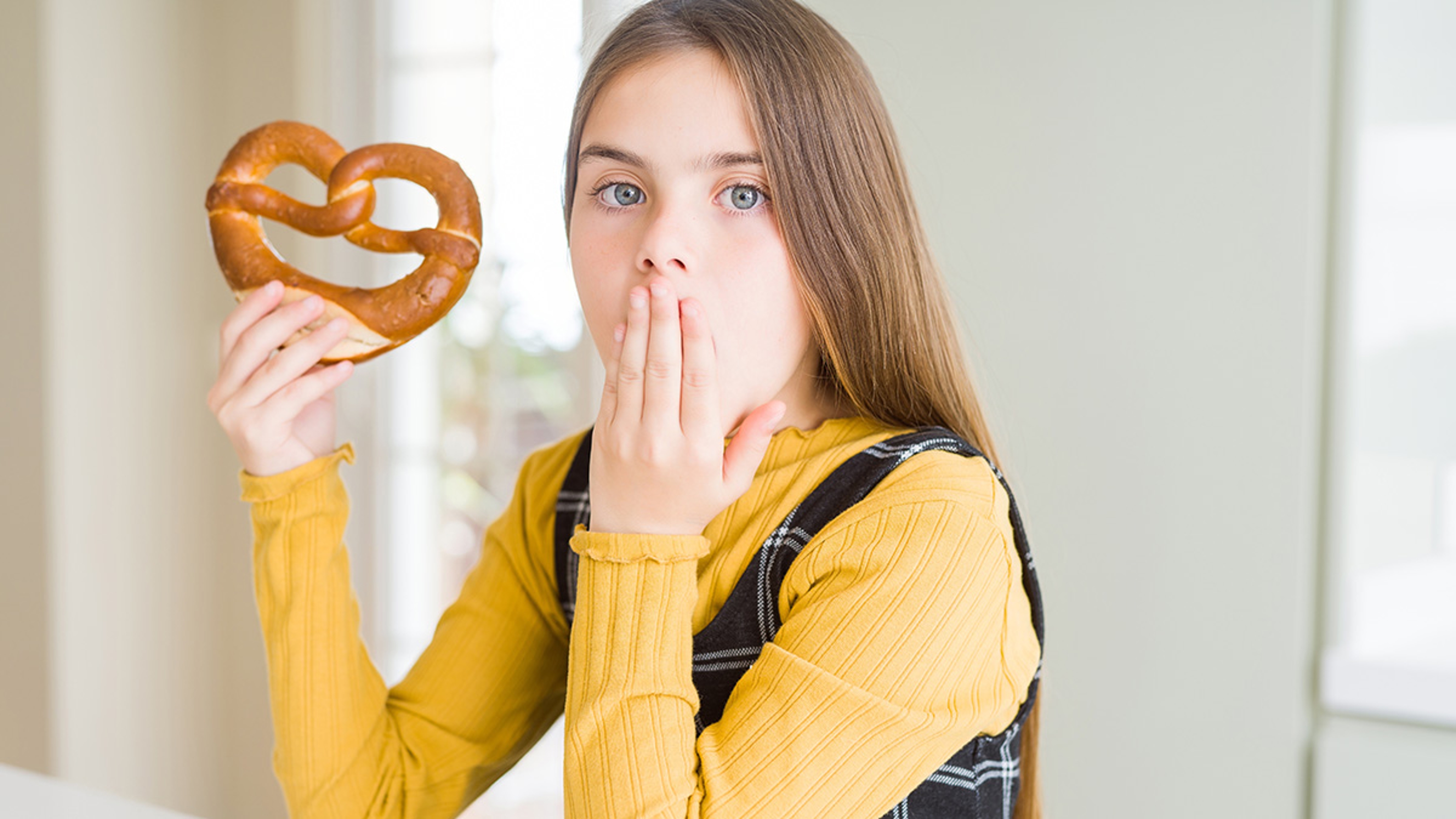 Article Cards Featured Image a girl eating a pretzel