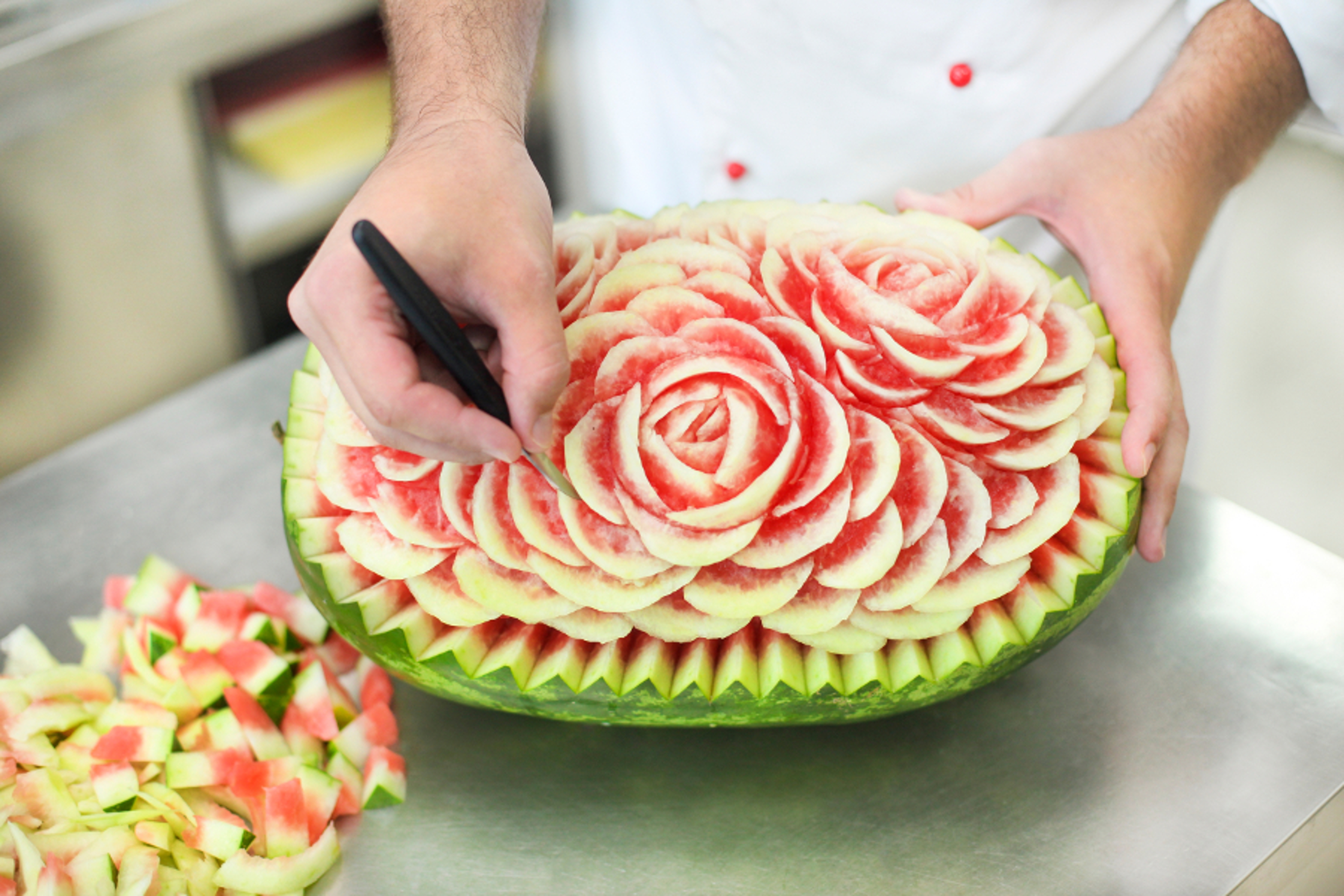 Article Cards Featured Image Chef carving a watermelon in a kitchen