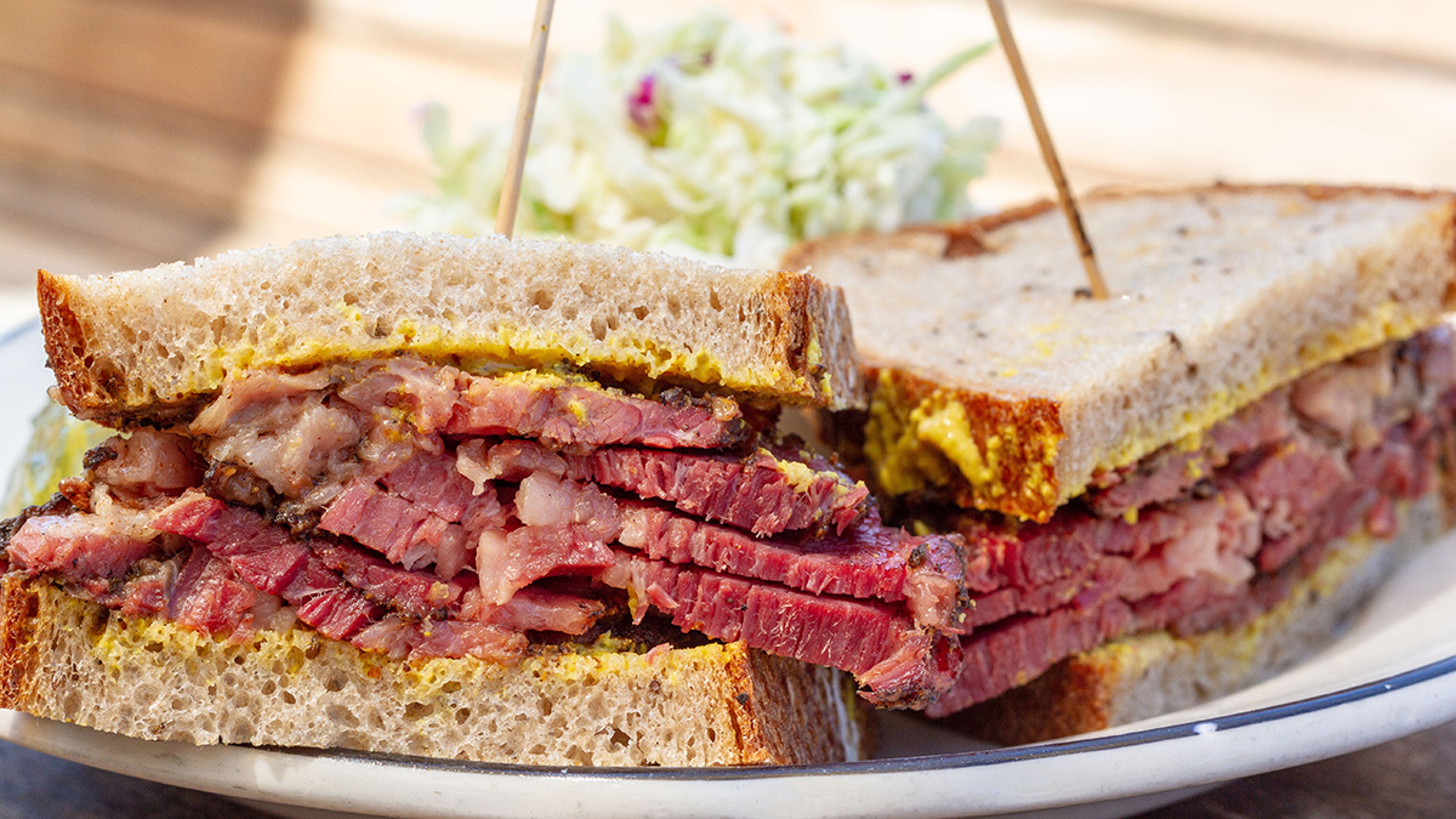 Pastrami sandwich on rye on a plate.