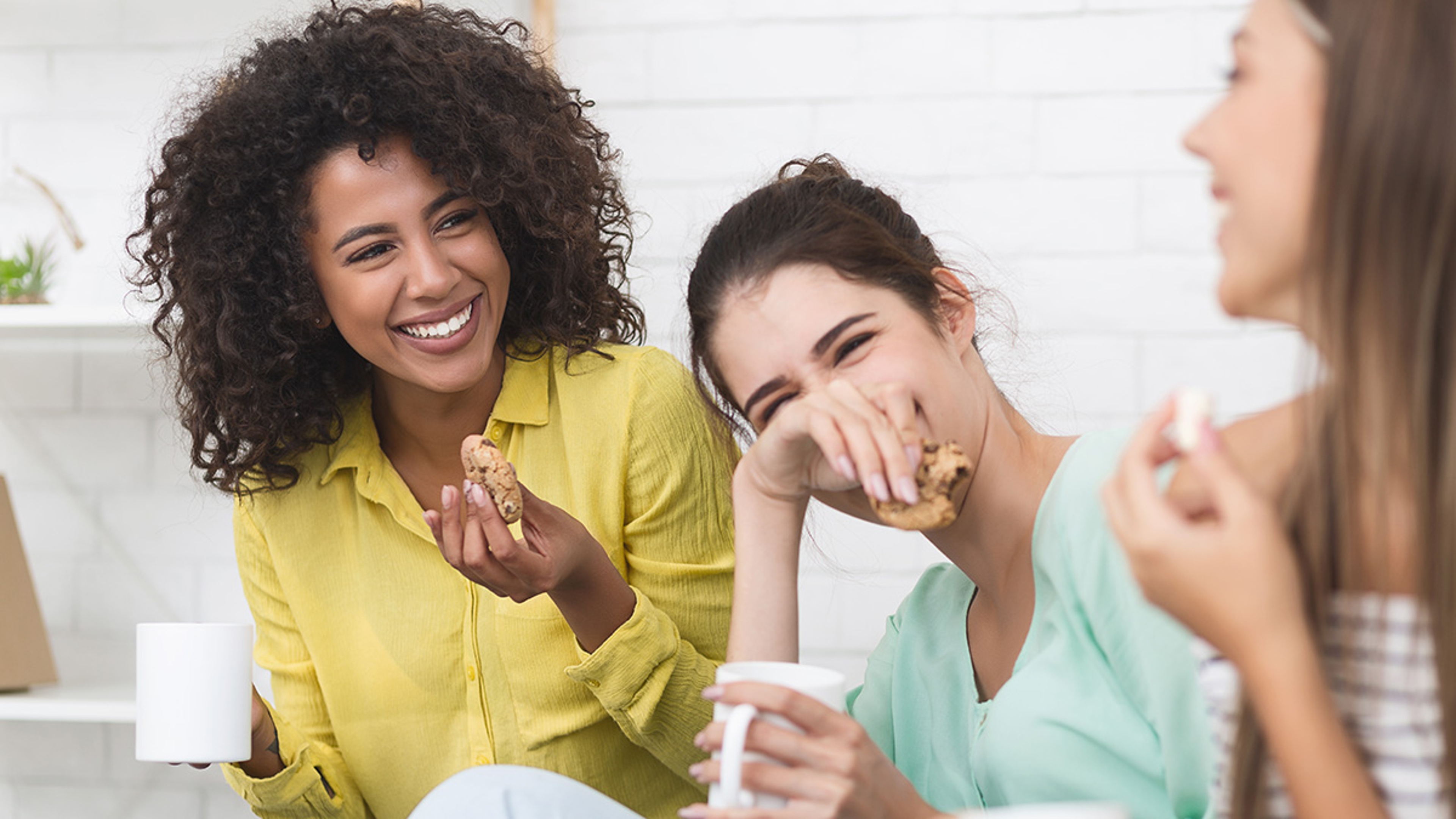 Article Cards Featured Image Happy girls drinking tea and eating sweets, enjoying time together at home