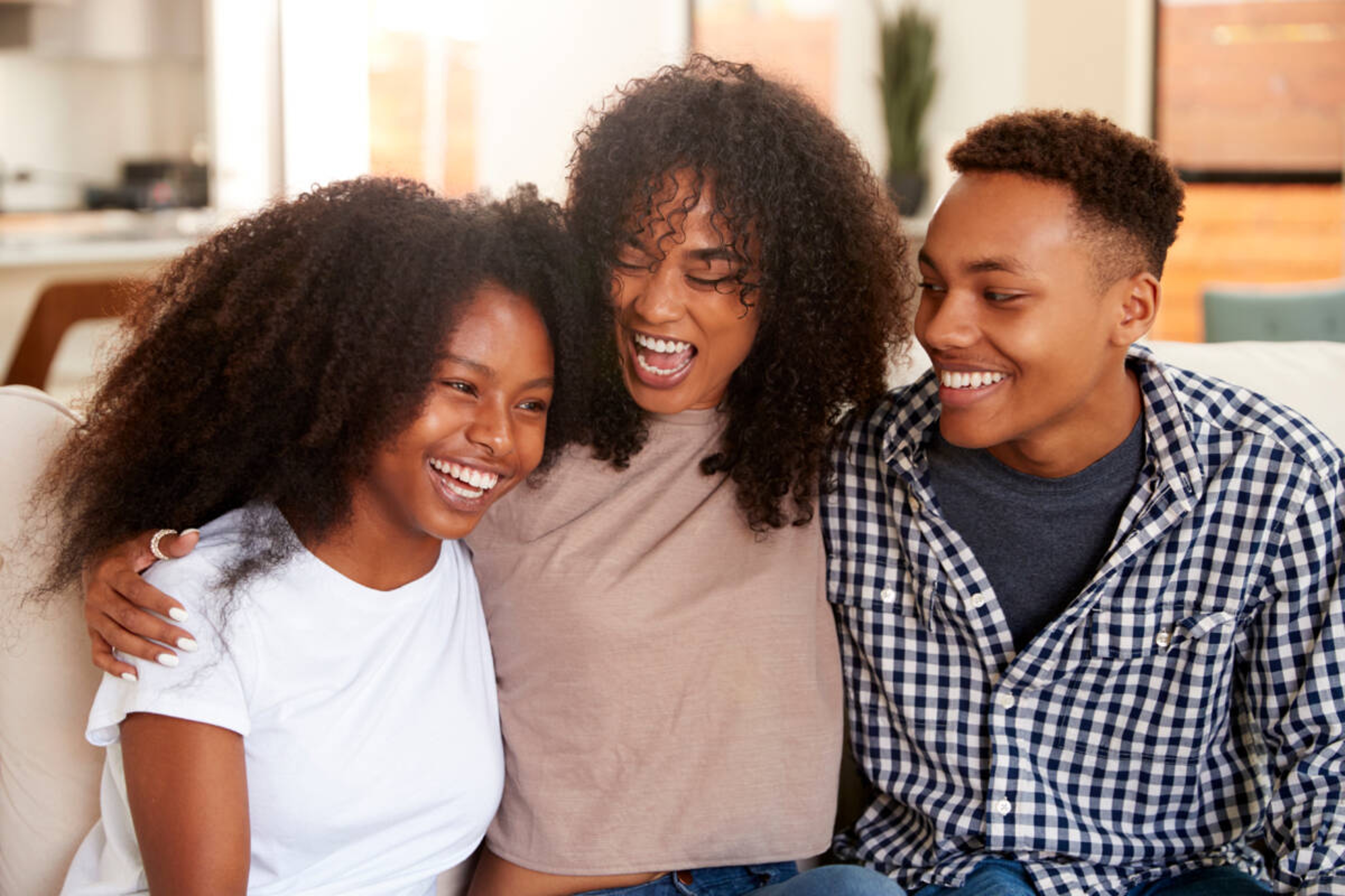 Article Cards Featured Image Black teen and young adult brother and sisters relaxing together, close up